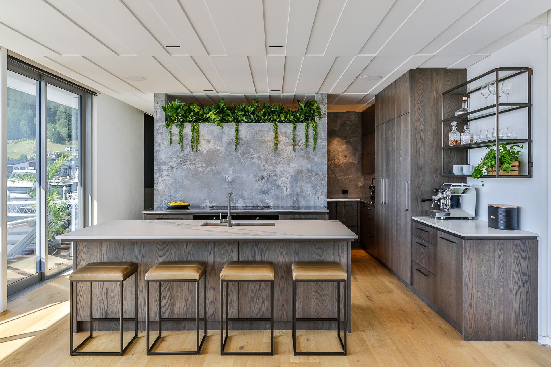 A stunning use of a splashback niche using hanging plants in this kitchen in Pauanui.