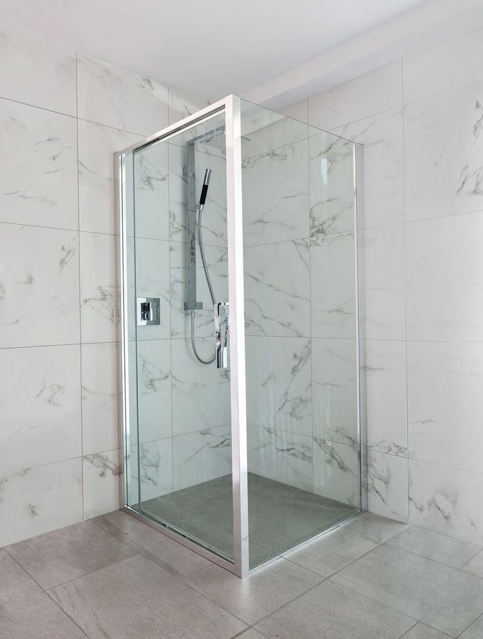 Pivot door shower screens can open inward or outward, depending on the positioning of the mechanism and hinge. Featured product: Torsion Square Corner Inswing Shower.