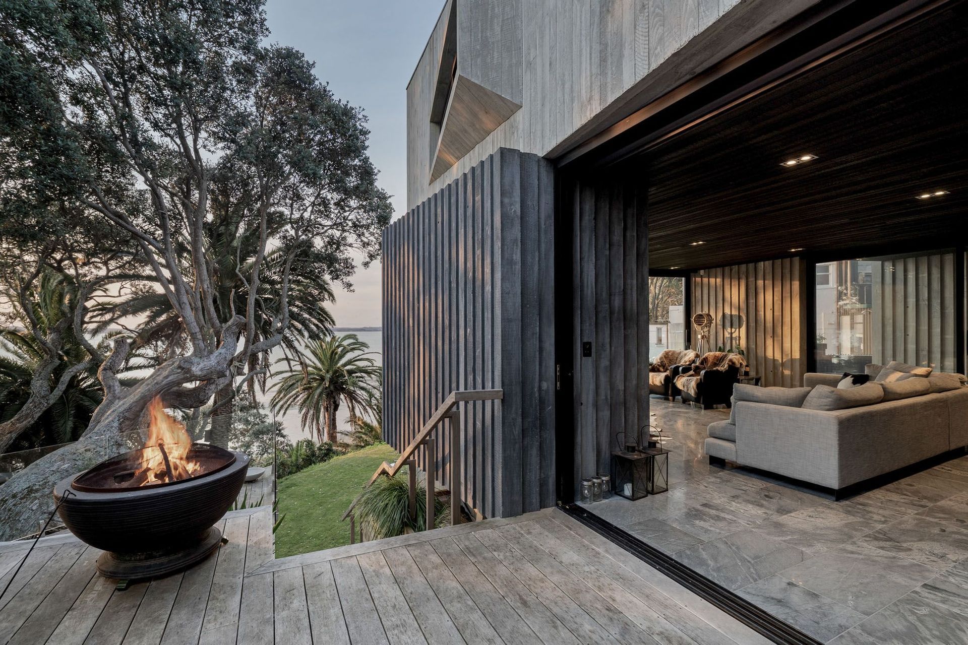 An outdoor fire pit can instantly enhance the abmience of a space, seen here in this exquisite home in Pt Chevalier.