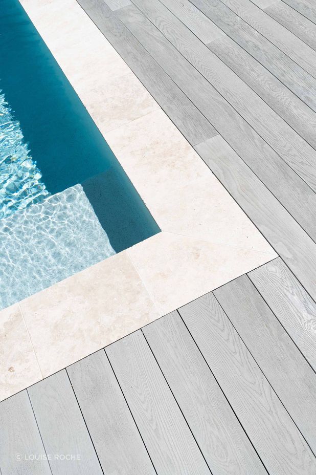 "Millboard Smoked Oak was the decking colour of choice for this beautiful home as it ticked all the boxes. The classic silver grey colour complementing the soft calming pallet of the home as it wrapped around the front porch and pool area."