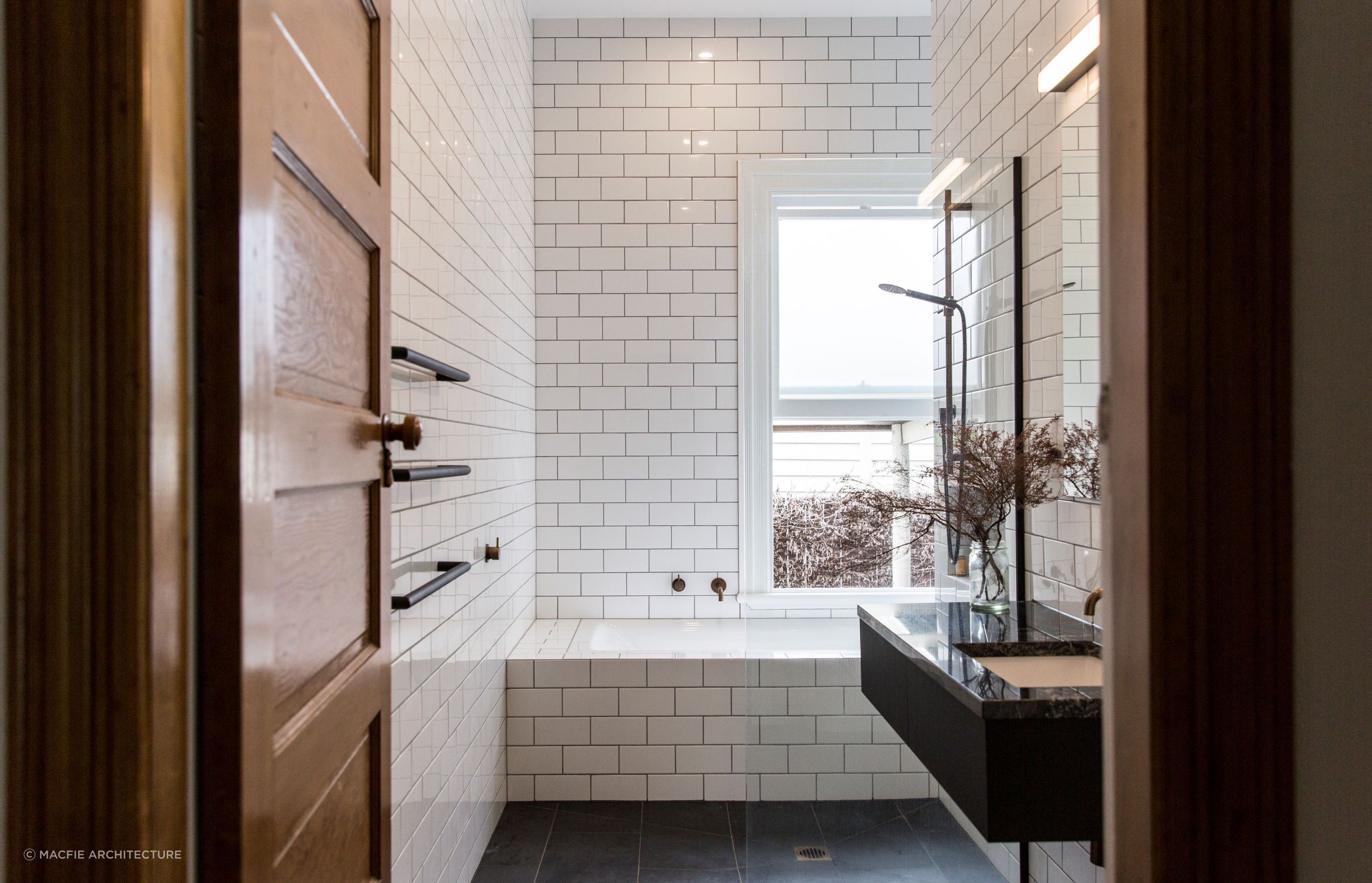 Floor-to-ceiling tiling, akin to that of a cosy wet room, showcases the best in contemporary bathroom styling in this Sandringham home.