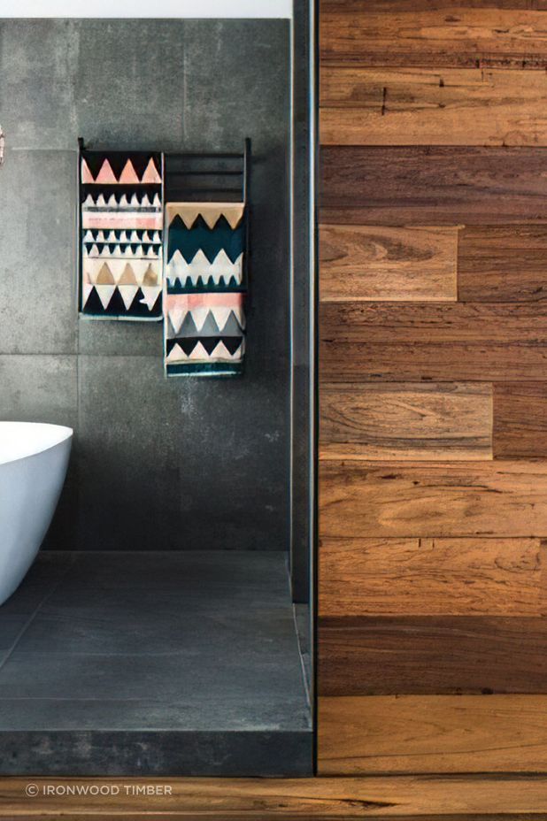These hardwood panels offer a striking contrast with the internal bathroom tiles.