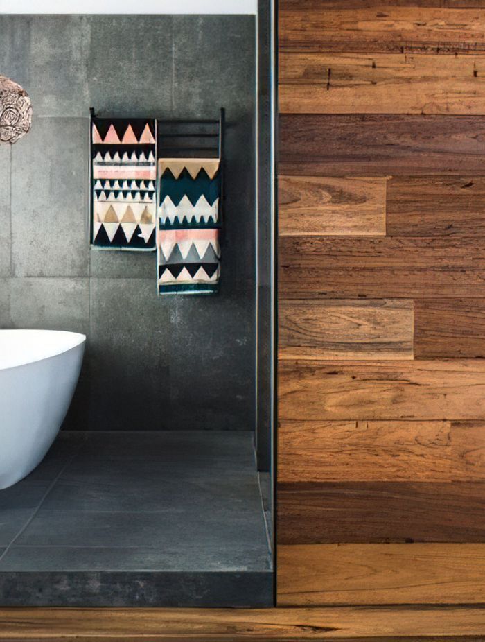 These hardwood panels offer a striking contrast with the internal bathroom tiles.