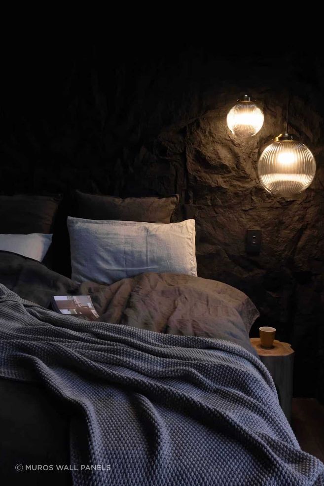 At The Rise by Lucy Furniss Design, a bedroom accent wall features Muros Black Rock panels, with bathroom and living spaces clad in Roughcast Concrete in Rust.