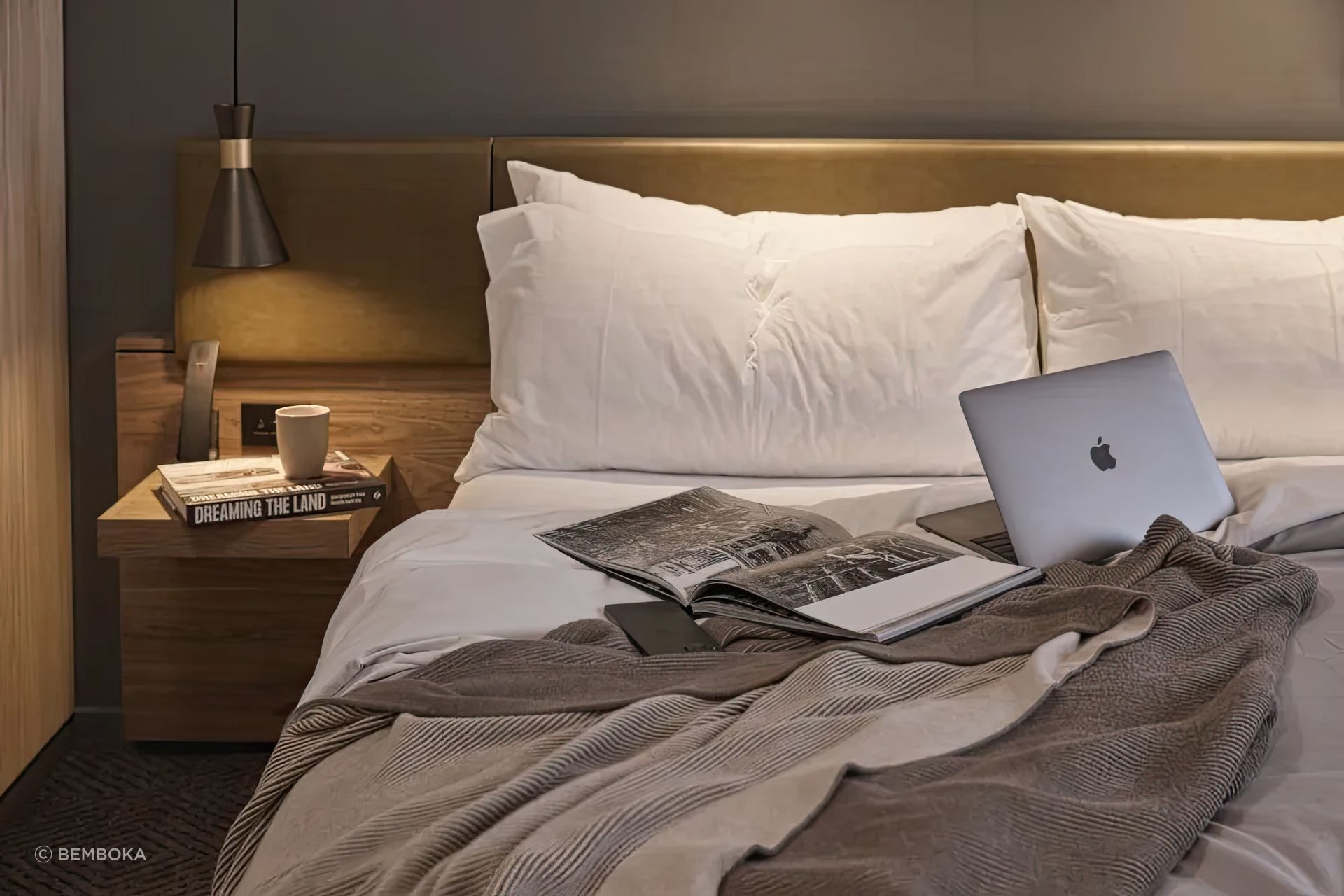 Bemboka percale duvet and reversible rib cotton throw styled in a moody, layered bedroom at Rydges, Melbourne.