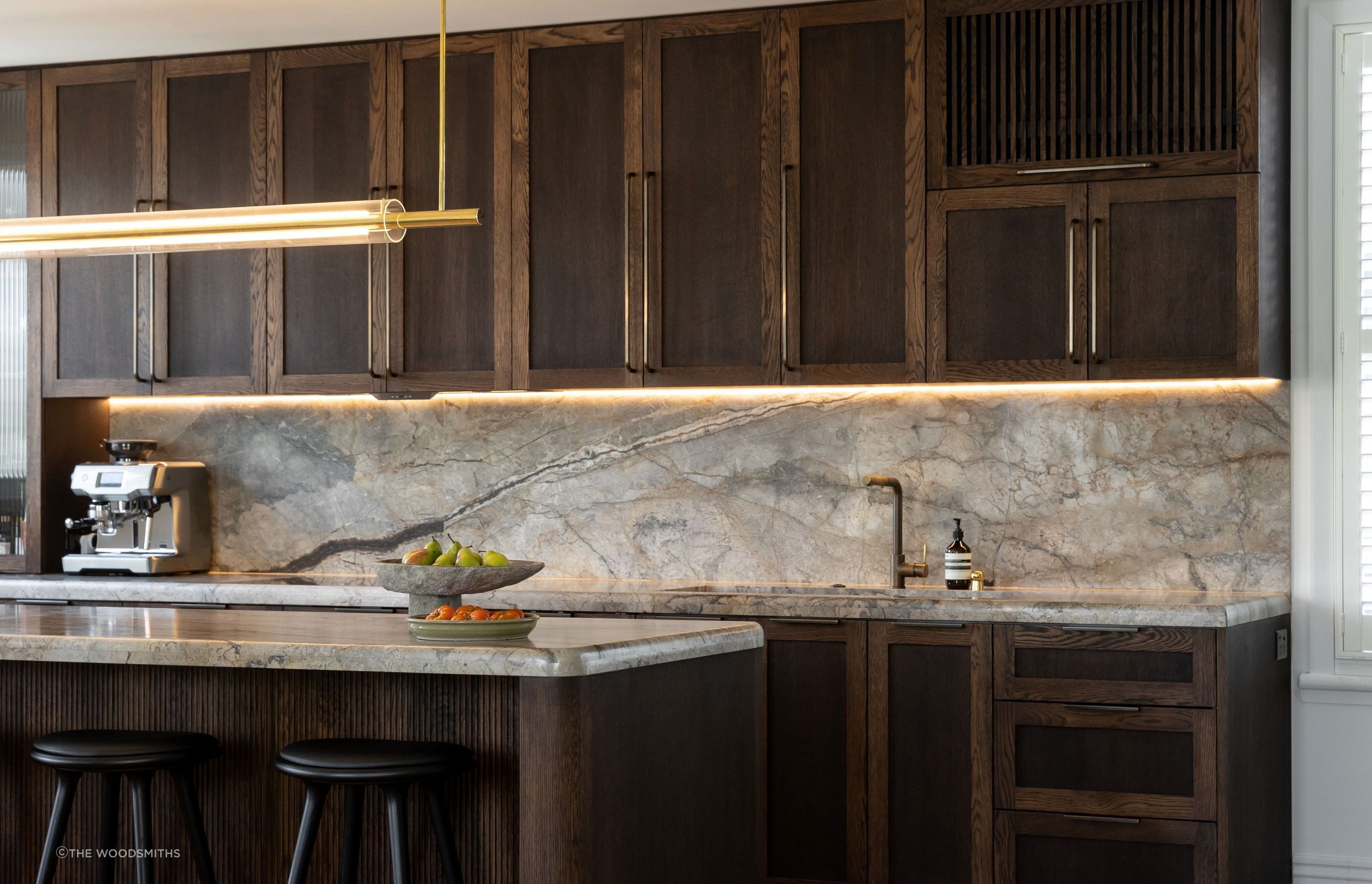 Solid wood cabinets, like these beautiful ones by The Woodsmiths, bring warmth and texture into a space.