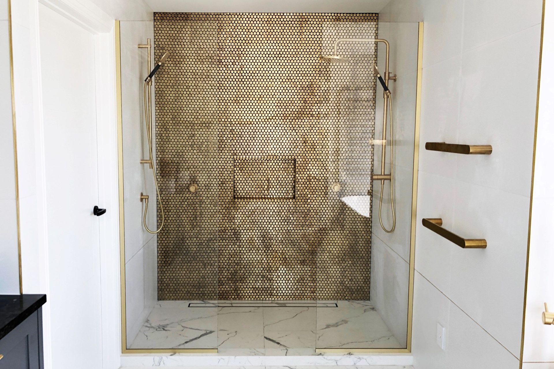A dazzling mosaic of tiles, complemented by equally luxurious Glass Shower Screens from Haynes Glass.