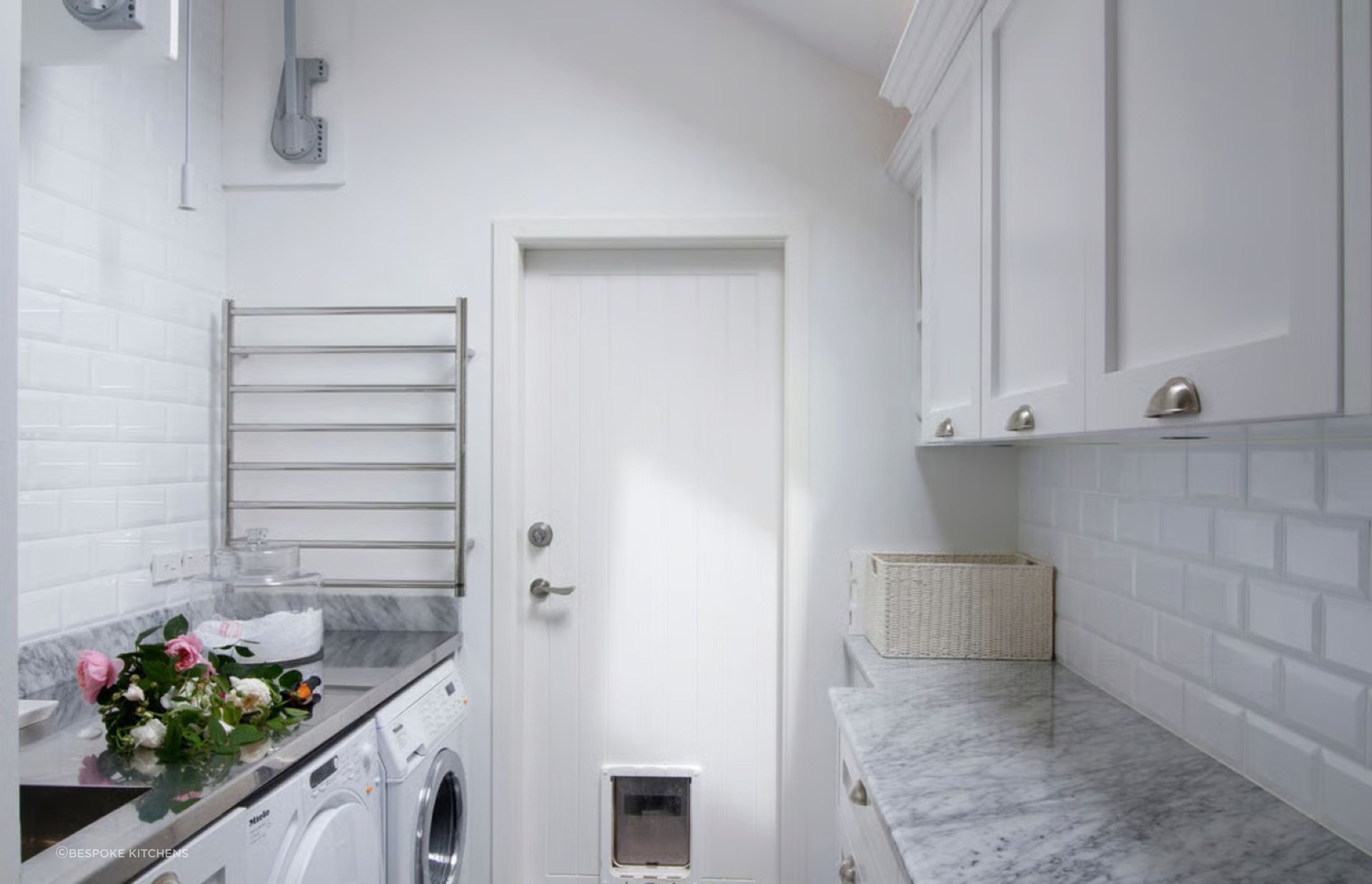 A heated towel rail is a great inclusion for a laundry room, adding versatility to the space as seen here in this St Heliers residence by Bespoke Kitchens.