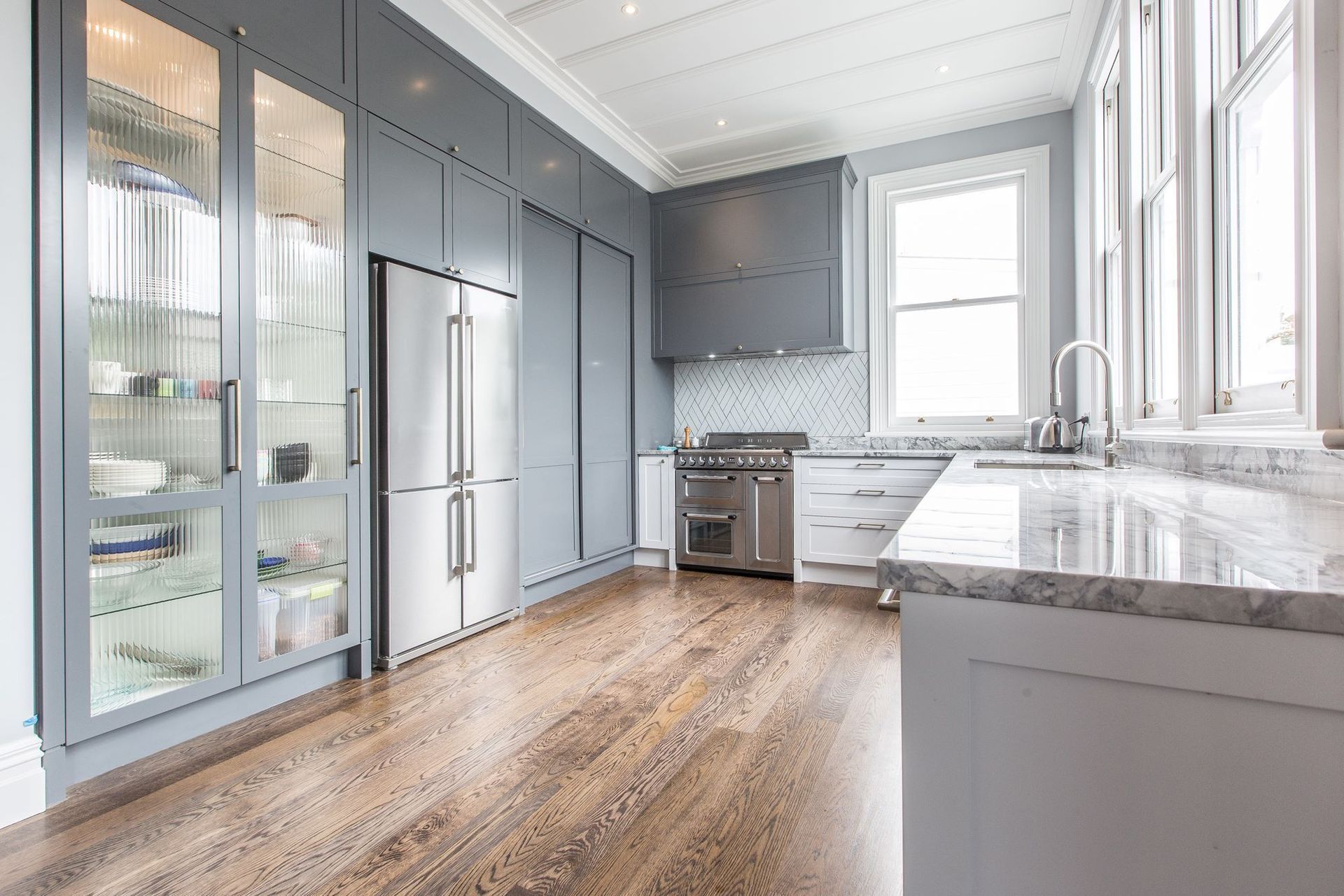This unique splashback tile arrangement creates a focal point for the eye, enhancing the spaciousness of this exquisite kitchen in St Marys Bay.