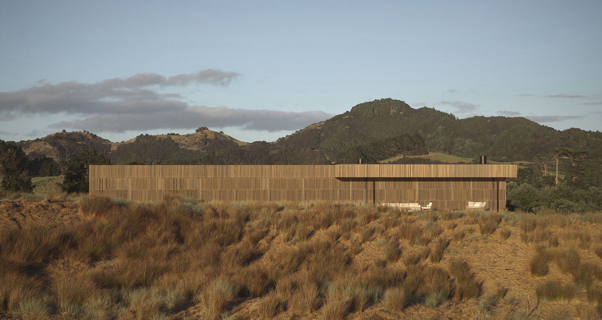 Tahi House sits low within the restored dunes of Pātaua North, its restrained form shaped by site, climate and long-term care for the land.