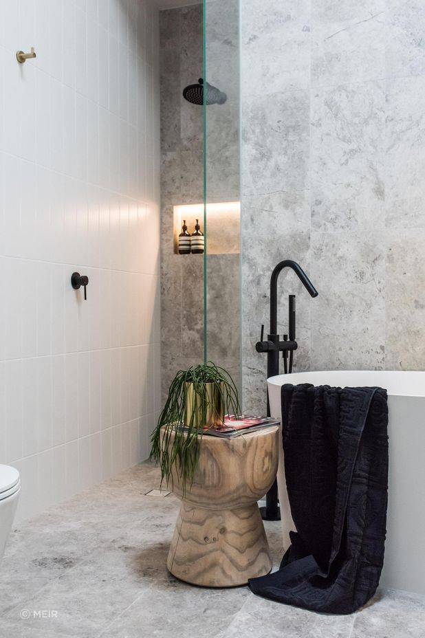 A cosy walk-in shower, featuring the bold Round Wall Shower Arm in Matte Black from Meir.