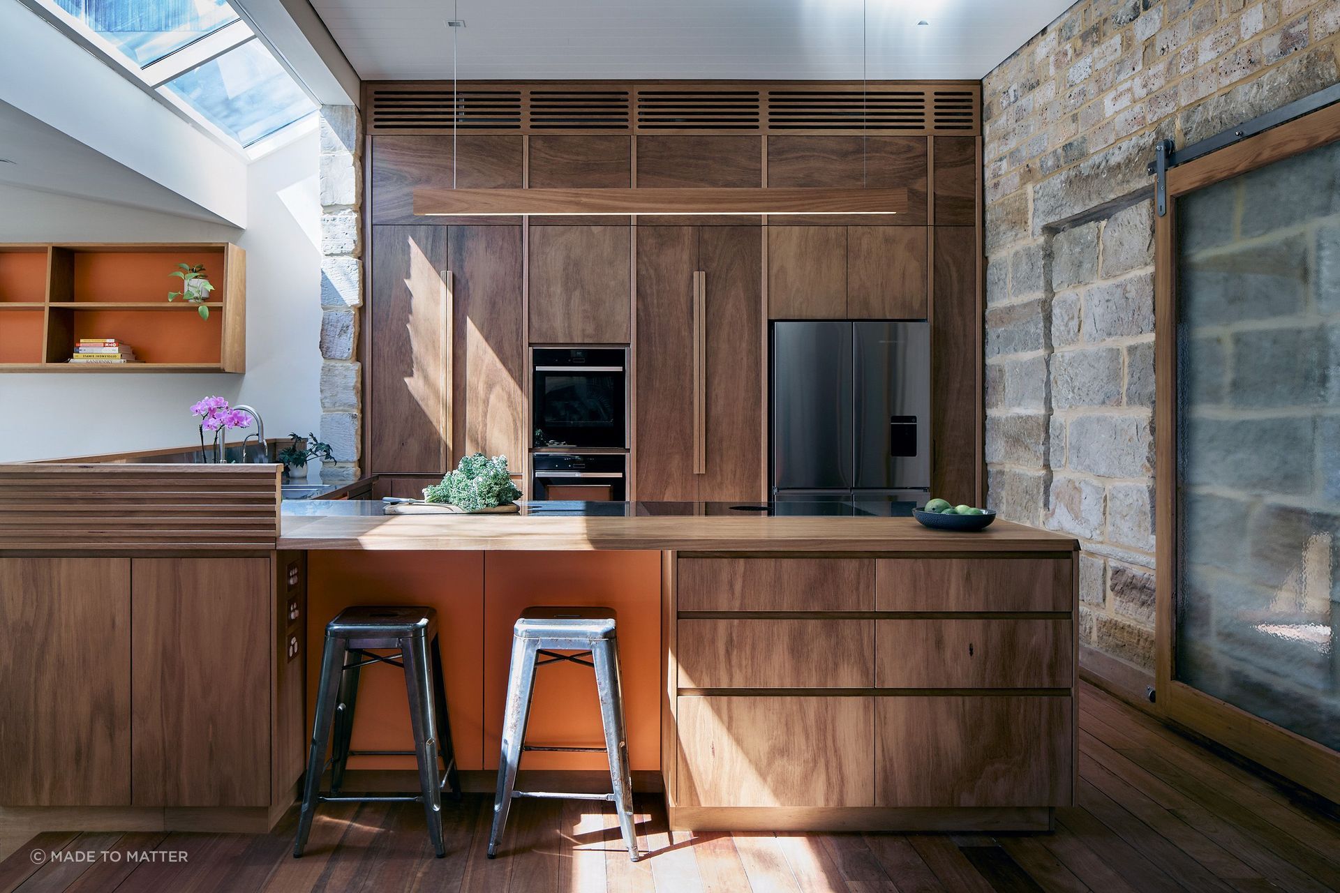 The large swaths of timber, including the switch light, contrast well with the exposed sandstone walls.