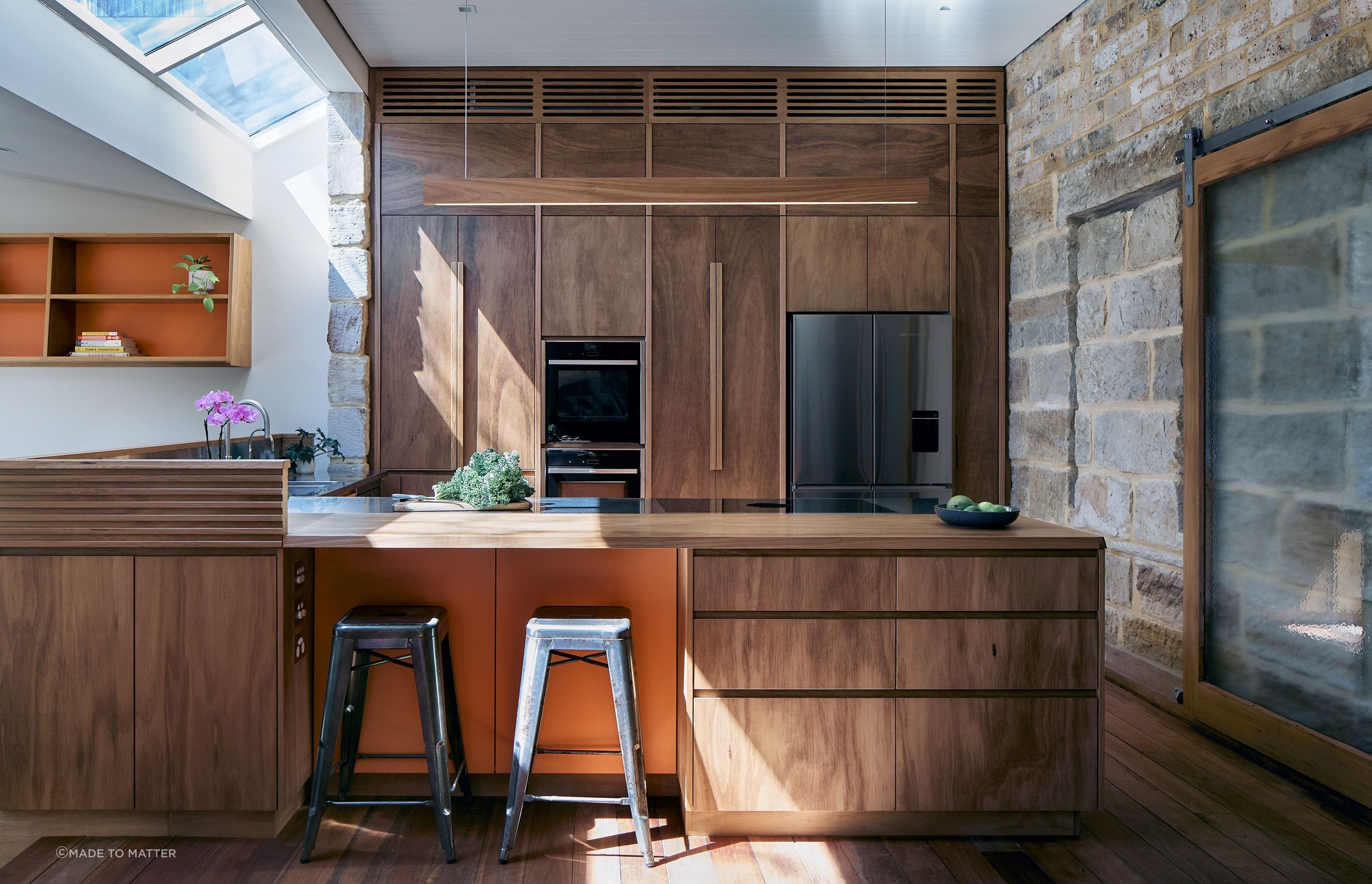 The large swaths of timber, including the switch light, contrast well with the exposed sandstone walls.