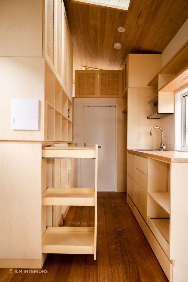 This tiny house features clever space-saving cabinetry by Ilm Interiors.
