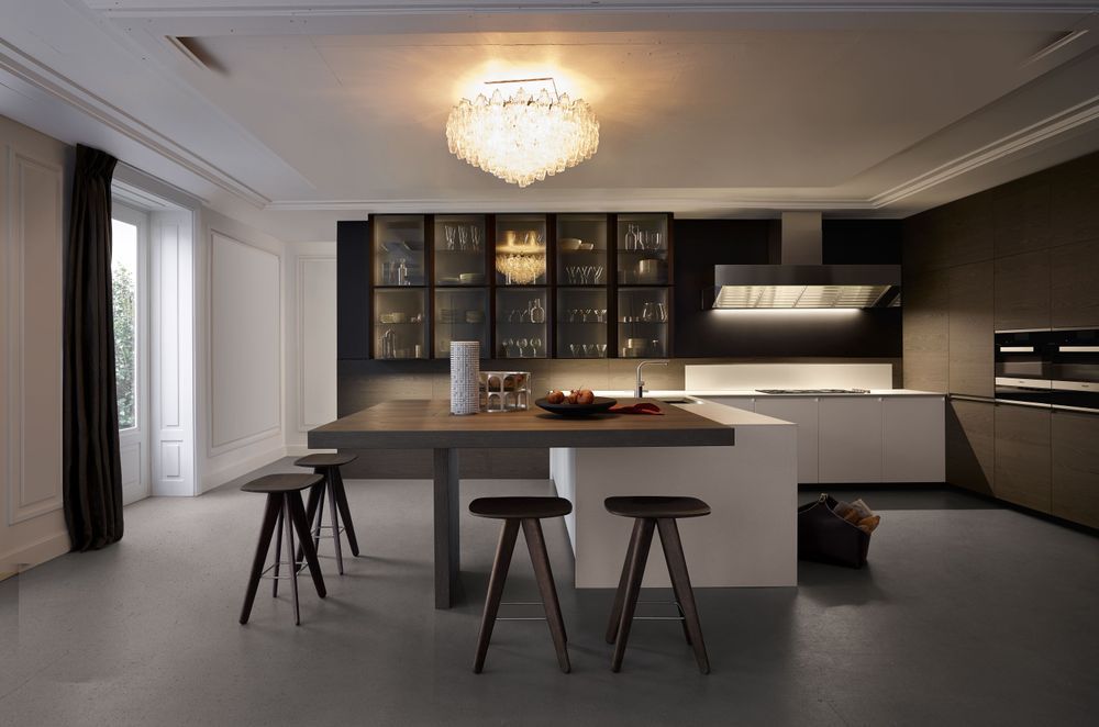 An elegant chandelier can act as a focal point in a modern kitchen. Featured product: Trail Kitchen
