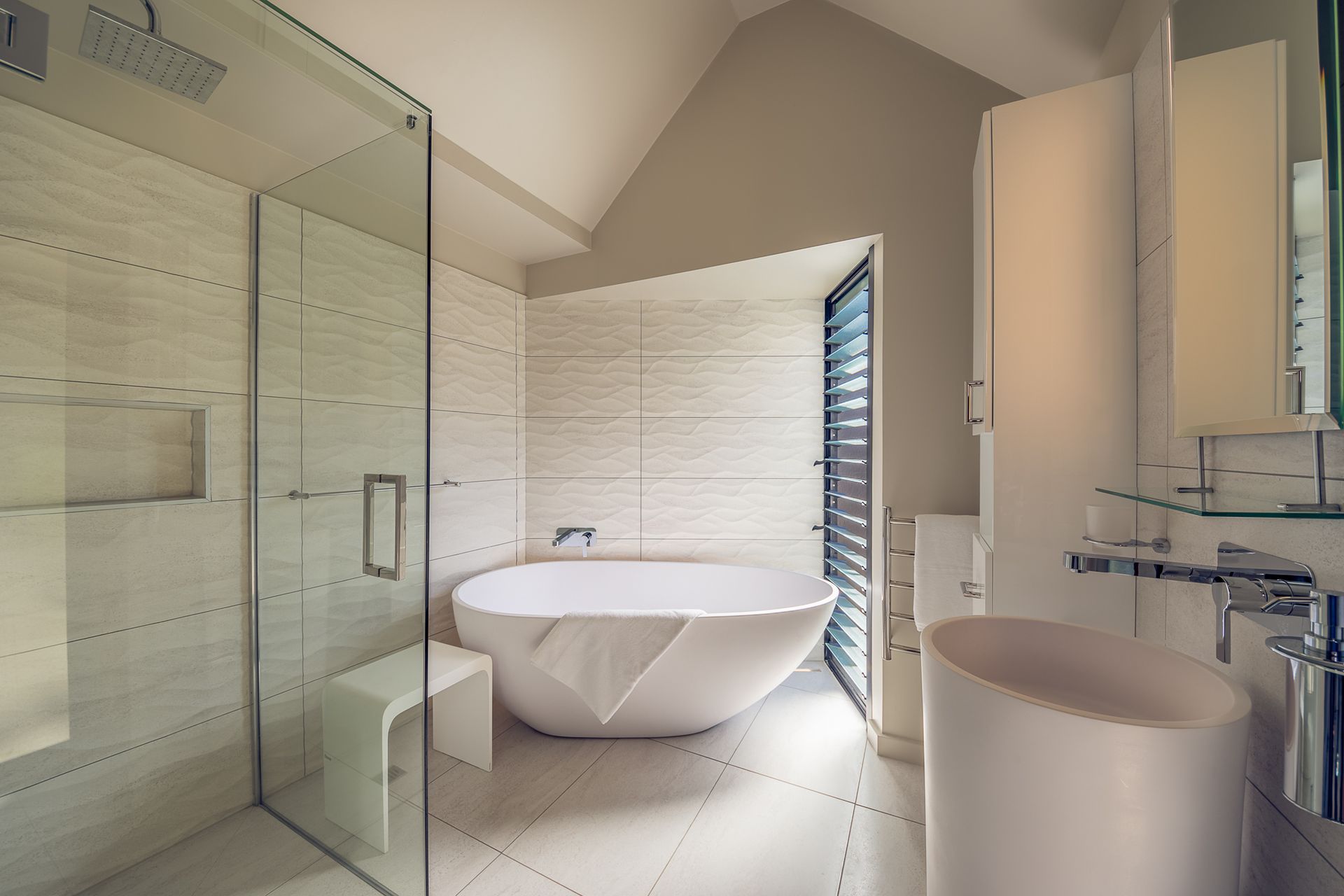 Dimension, depth and direction with the wave form textured tiles used in this Tutukaka bathroom renovation.