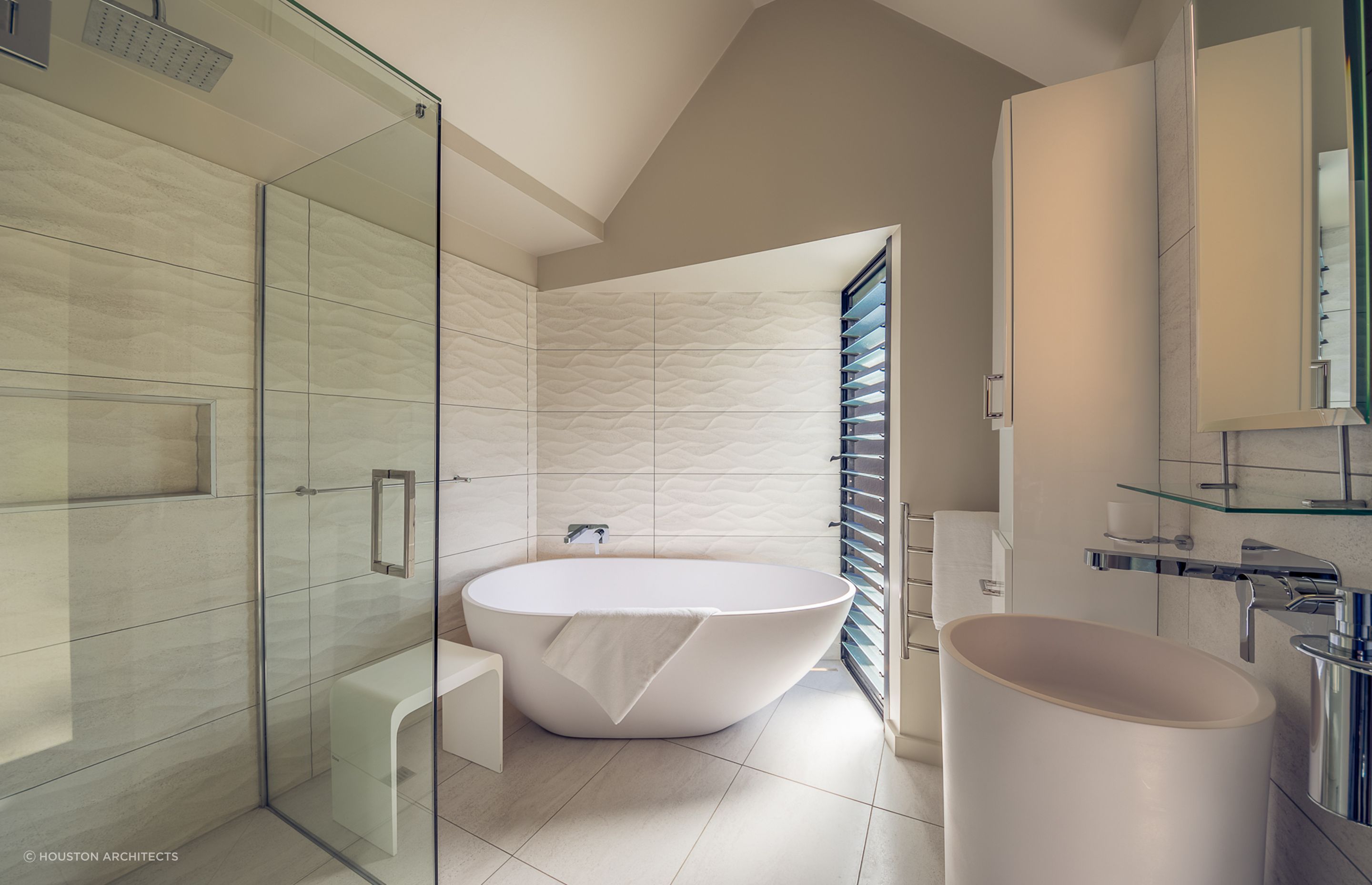 Dimension, depth and direction with the wave form textured tiles used in this Tutukaka bathroom renovation.