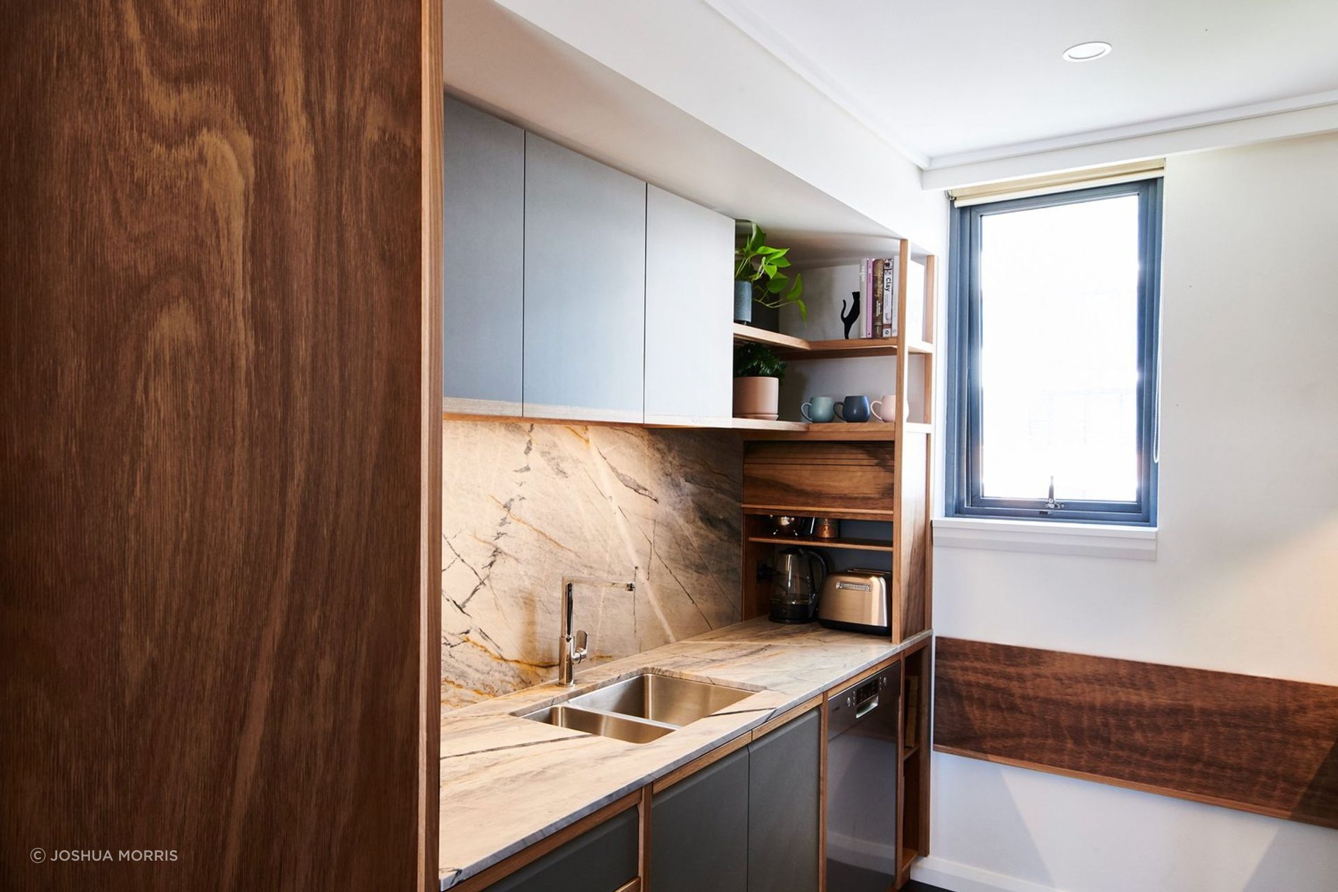 This neat Blackbutt tambour door is a perfect solution for this tidy kitchen in Prymont. | Photography: Joshua Morris