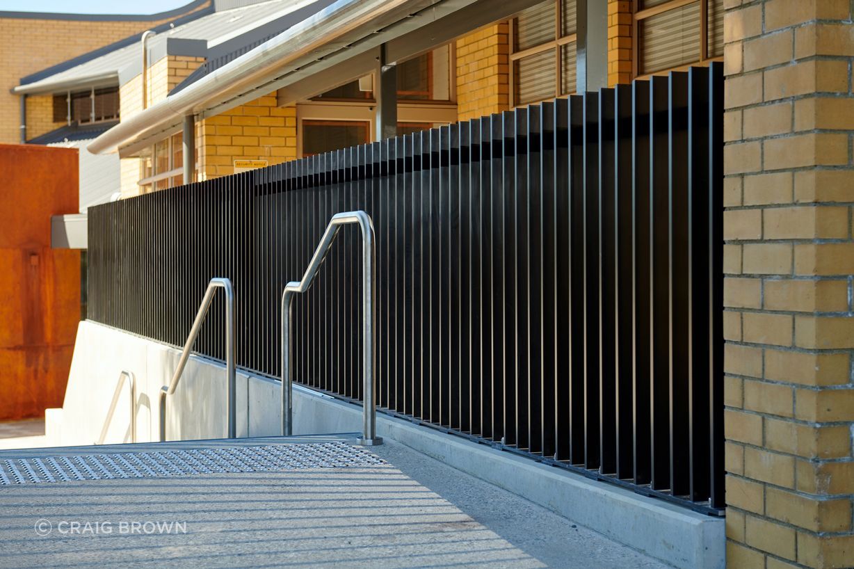 A custom Topline balustrade featuring heavy-duty vertical fins in a CTH2 profile (60 x 16mm), paired with an interlinking VRR handrail set to the side for added safety and accessibility.