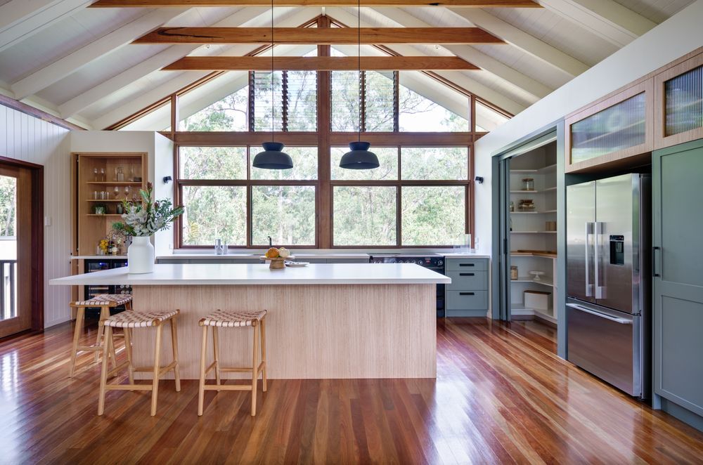 Expansive kitchen windows allow abundant natural light to fill a space, helping to cut down on energy bills while offering great scenic views. Photography: Alan Bouvier.