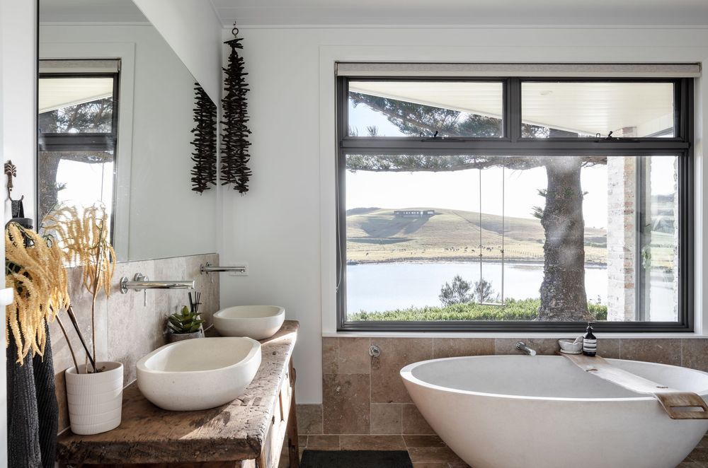 Modern coastal bathrooms seamlessly blend with their natural surroundings, capturing the essence of the shore, particularly in their decor.
