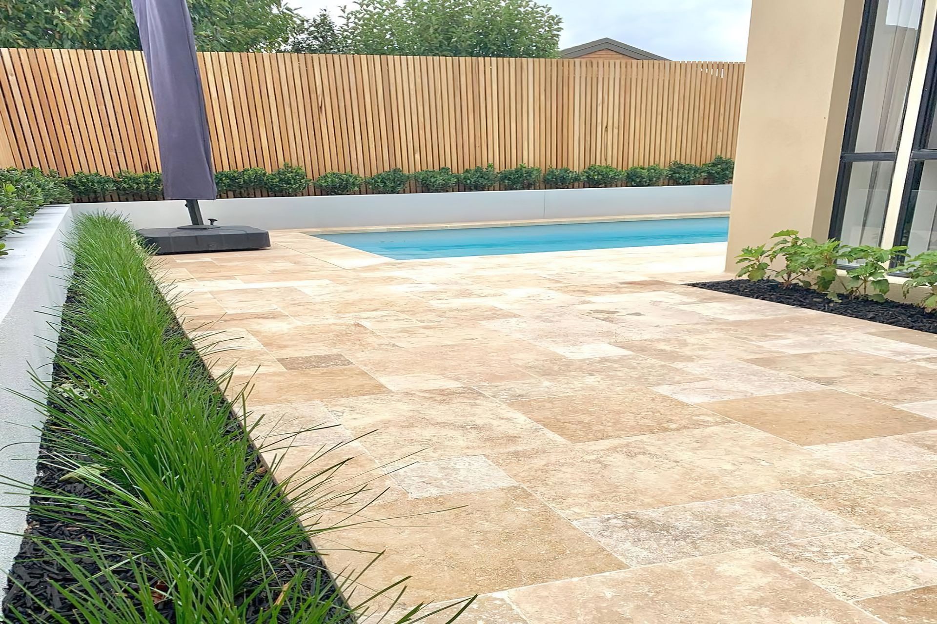 Travertine tiles are a stylish option for a patio.