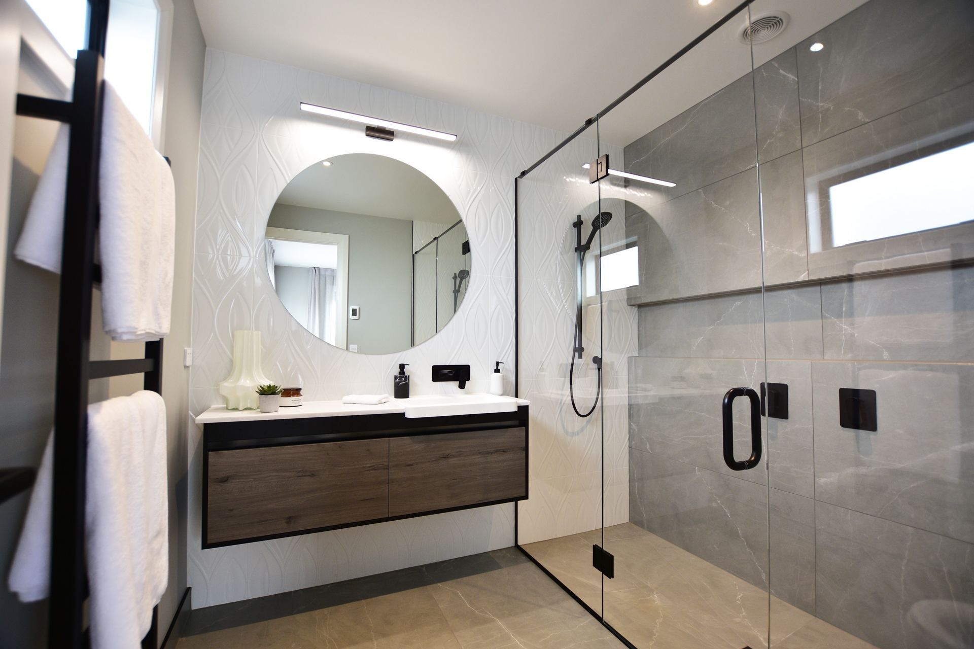 A large bathroom mirror, like the custom design by Haynes Glass, can enhance the feeling of spaciousness.