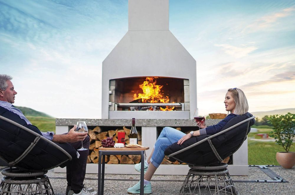 A stylish outdoor fireplace can transform a patio or outdoor dining area. Featured product: Premier Fireplace.