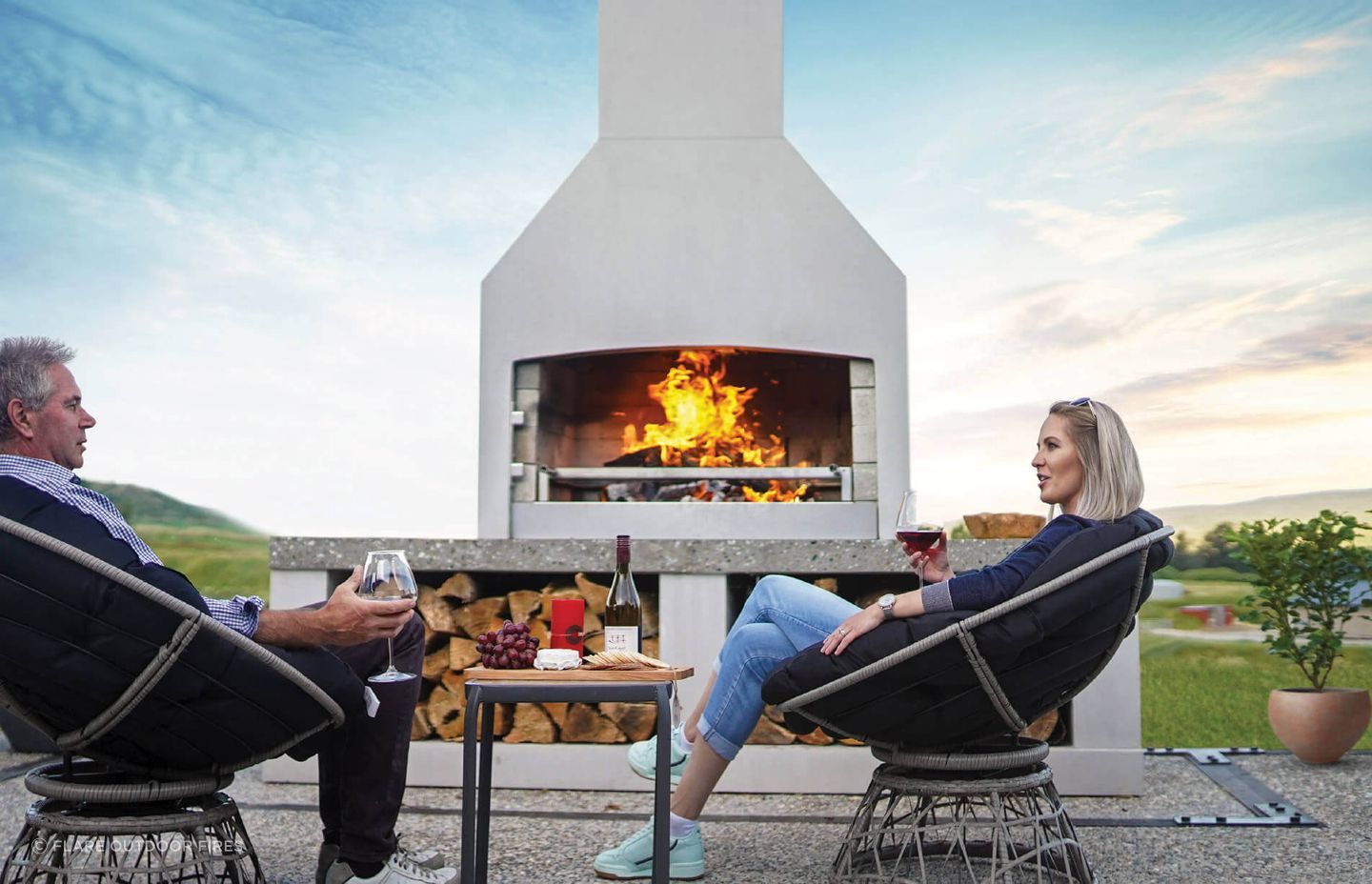 A stylish outdoor fireplace can transform a patio or outdoor dining area. Featured product: Premier Fireplace.