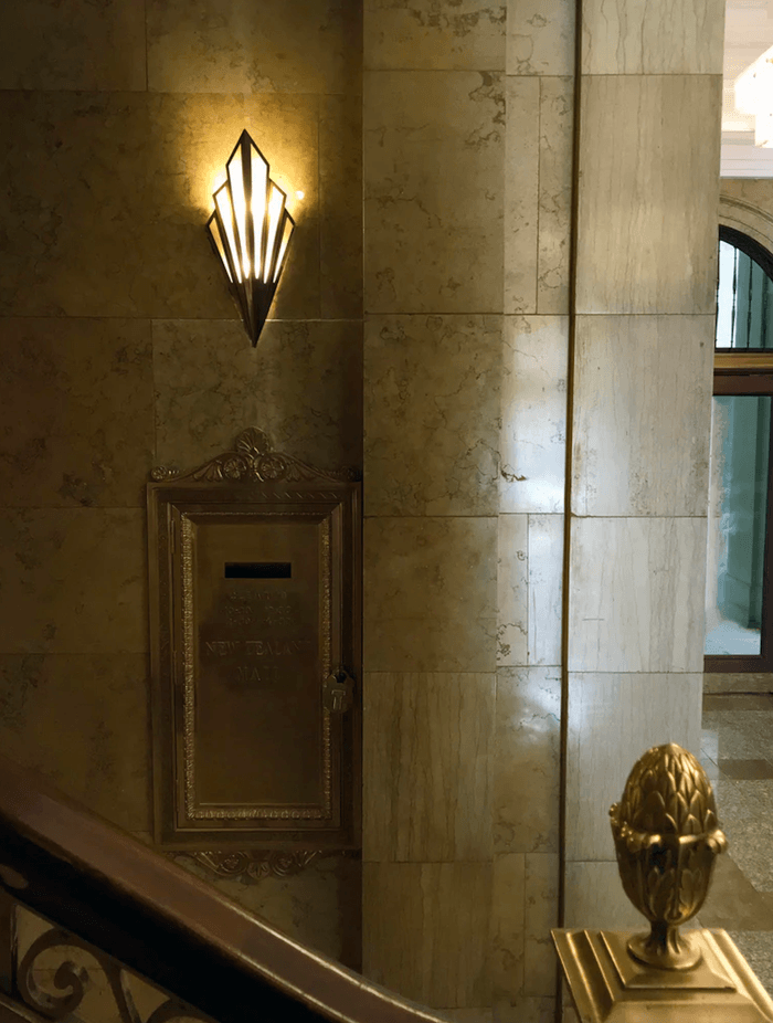 Custom-made Mikado wall fan-shaped wall lights in aged brass and alabaster are placed at considered intervals.