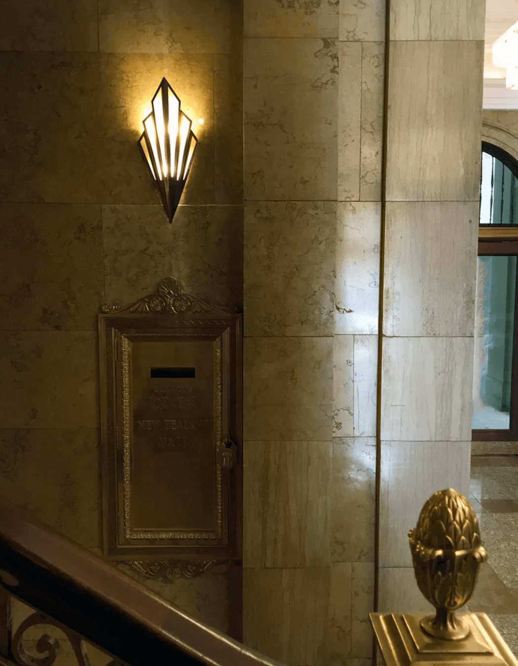 Custom-made Mikado wall fan-shaped wall lights in aged brass and alabaster are placed at considered intervals.