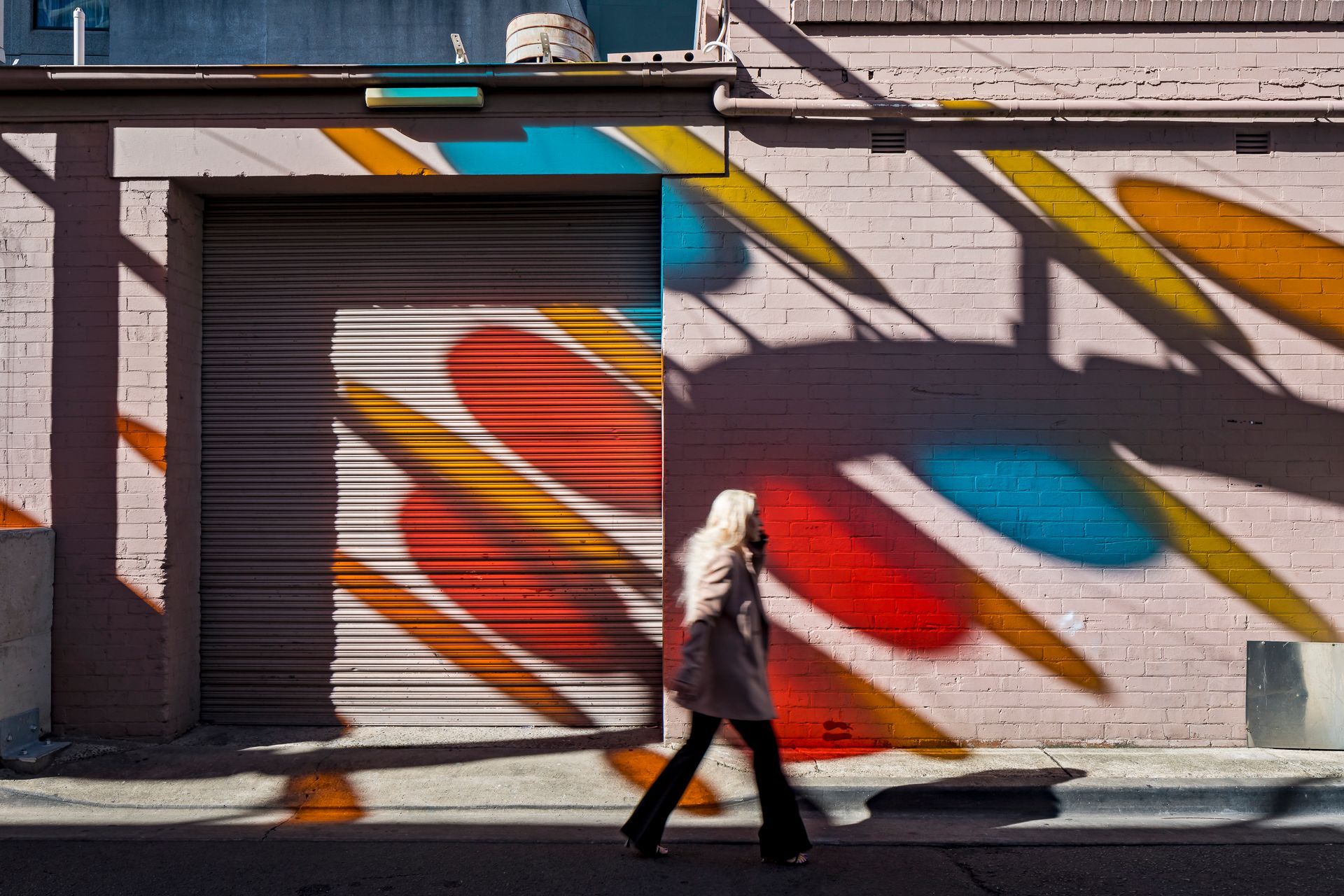 A public lighting installation by Colab Lighting throws pretty shapes across an old building.