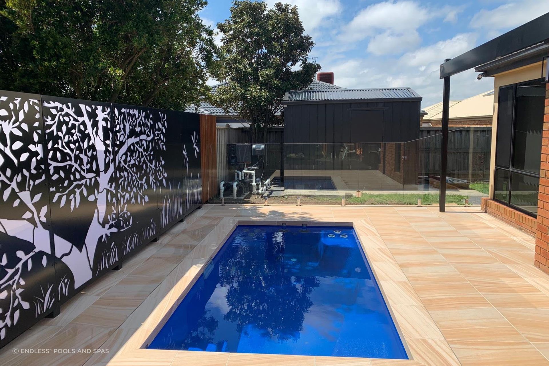 In-ground plunge pool can often be integrated into an existing outdoor feature such as deck or patio. Featured Product: Jaguar by Endless Pools and Spas.