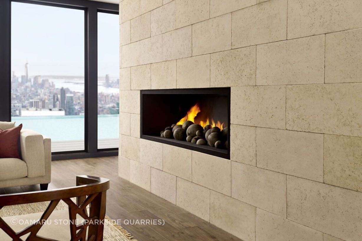 Ōamaru Stone provides a stunning backdrop for a modern fireplace.
