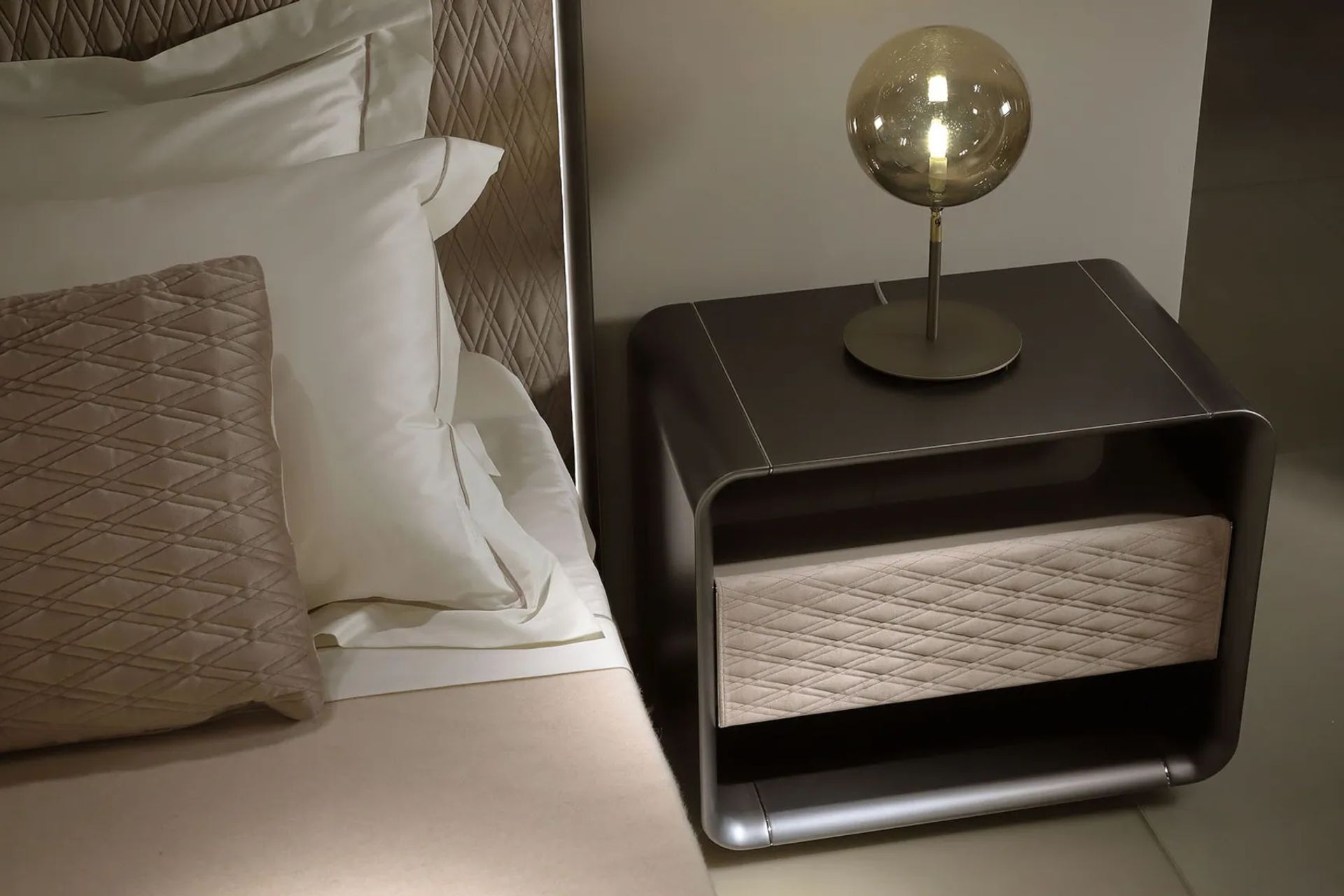 A patterned element, seen here with the emerald quilting on the Oh Bedside Table from Sarsfield Brooke Ltd can introduce a unique quality.