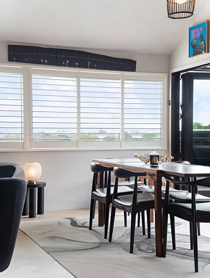 This space was elevated by the client’s original Bernard Vuarnesson dining table and Wegner chairs, paired with an Artisan “Ink Vapour” rug, Simon James “Offset” stool, “Bloom” lamp and Tom Dixon accessories—timeless pieces that endure.