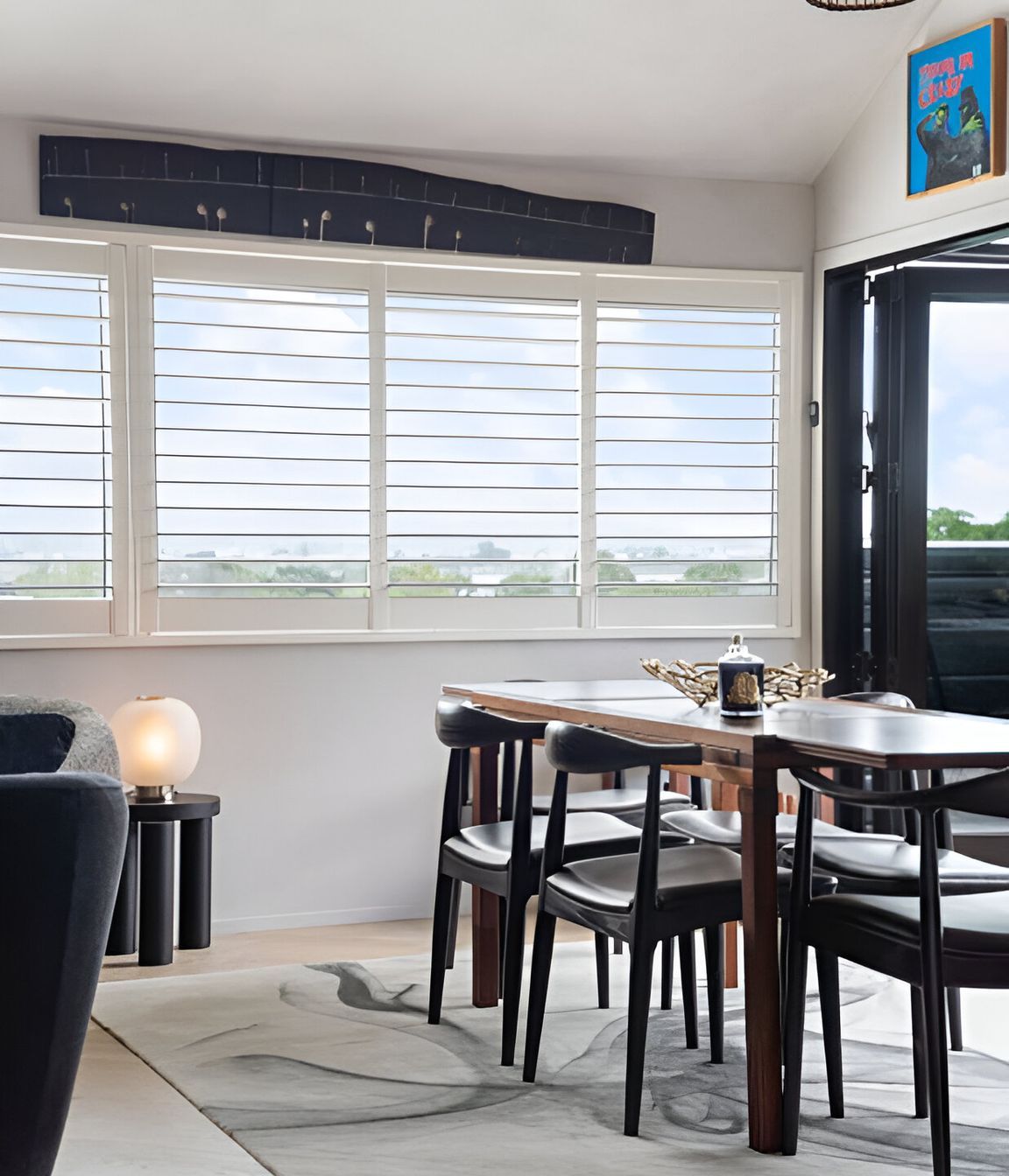 This space was elevated by the client’s original Bernard Vuarnesson dining table and Wegner chairs, paired with an Artisan “Ink Vapour” rug, Simon James “Offset” stool, “Bloom” lamp and Tom Dixon accessories—timeless pieces that endure.