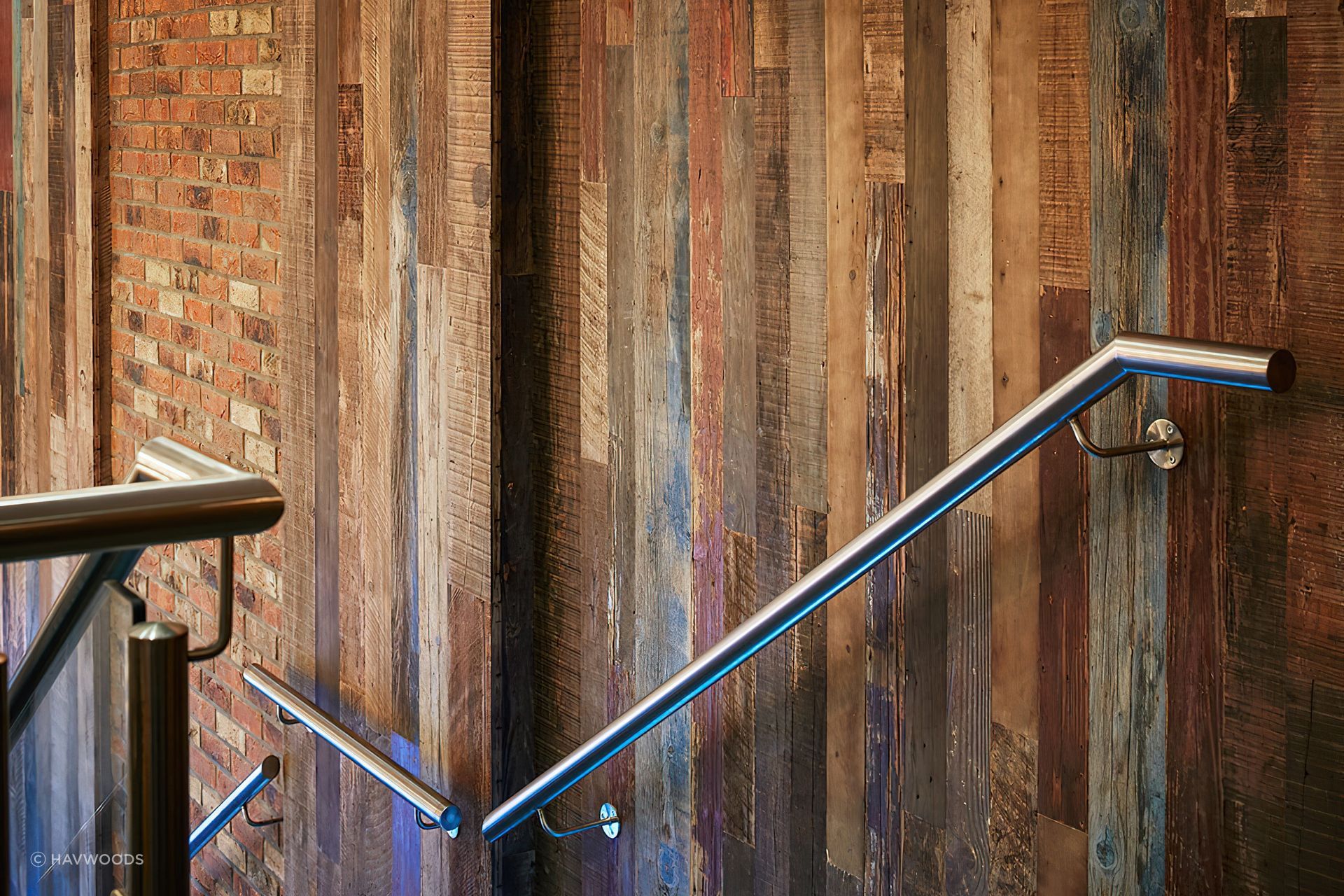 Reclaimed pine panels beautifully enhance staircases and other feature walls with their rustic charm. Featured product: REC2210 Organic Painted Pine