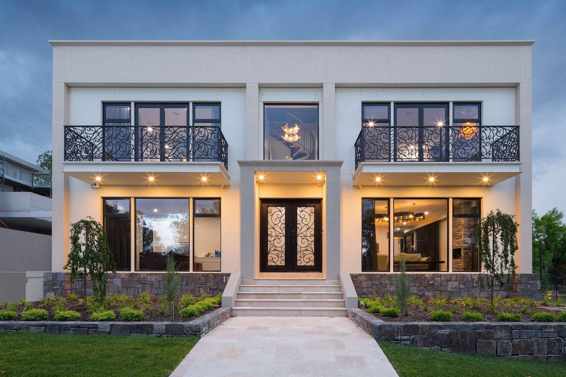 The entrance of this residence strikes a balance between tradition and modernity, with an elegant wrought-iron front door that offers both security and artistry. Featured project: Richardson by Architects Ring &amp; Associates