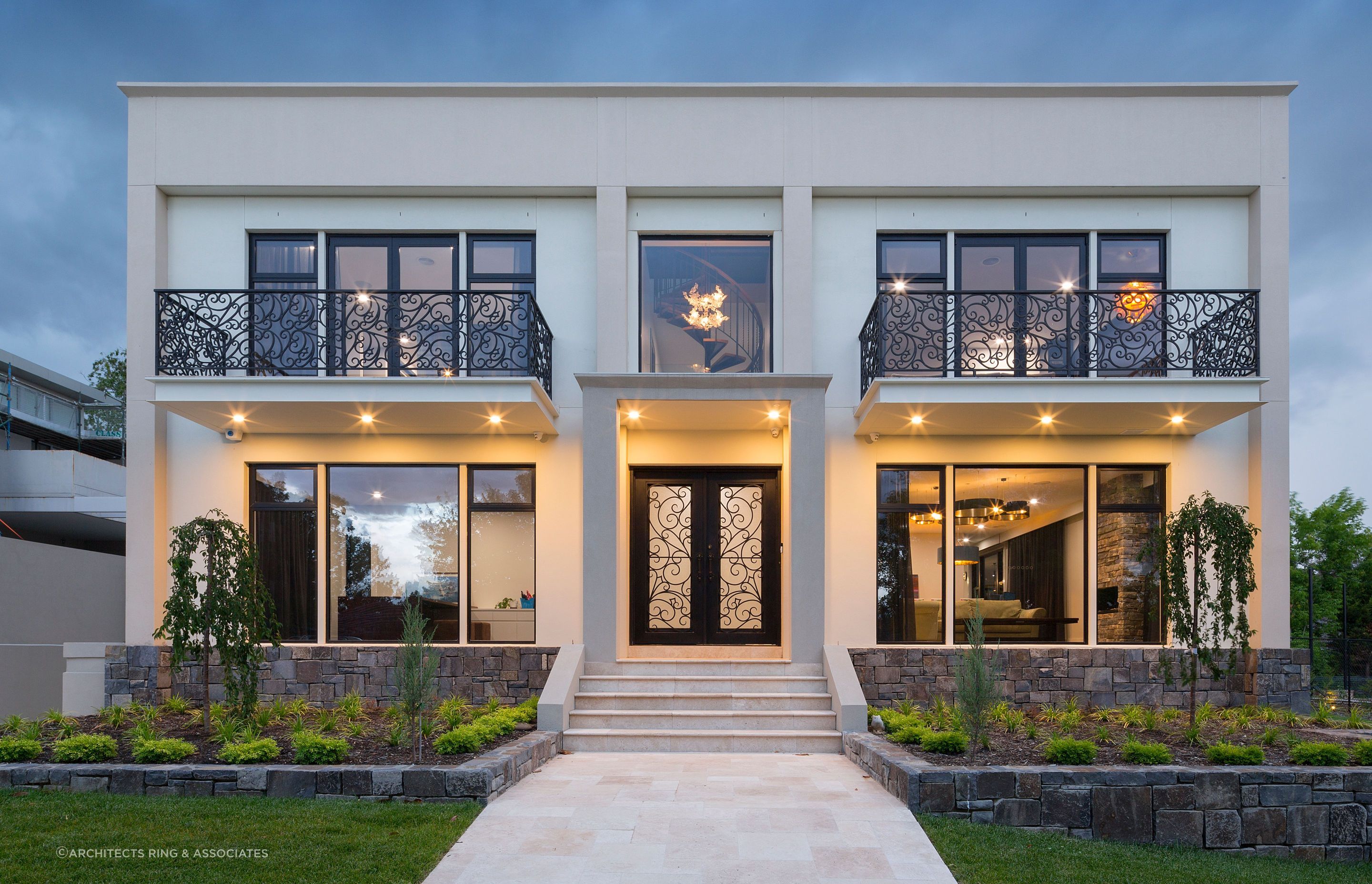 The entrance of this residence strikes a balance between tradition and modernity, with an elegant wrought-iron front door that offers both security and artistry. Featured project: Richardson by Architects Ring &amp; Associates