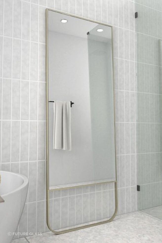A full-length bathroom mirror adds depth and dimension to a bathroom. Featured product: Radius Leaner Framed Mirror.