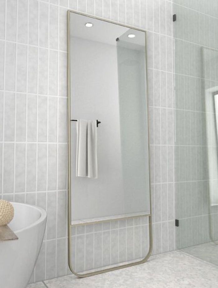 A full-length bathroom mirror adds depth and dimension to a bathroom. Featured product: Radius Leaner Framed Mirror.