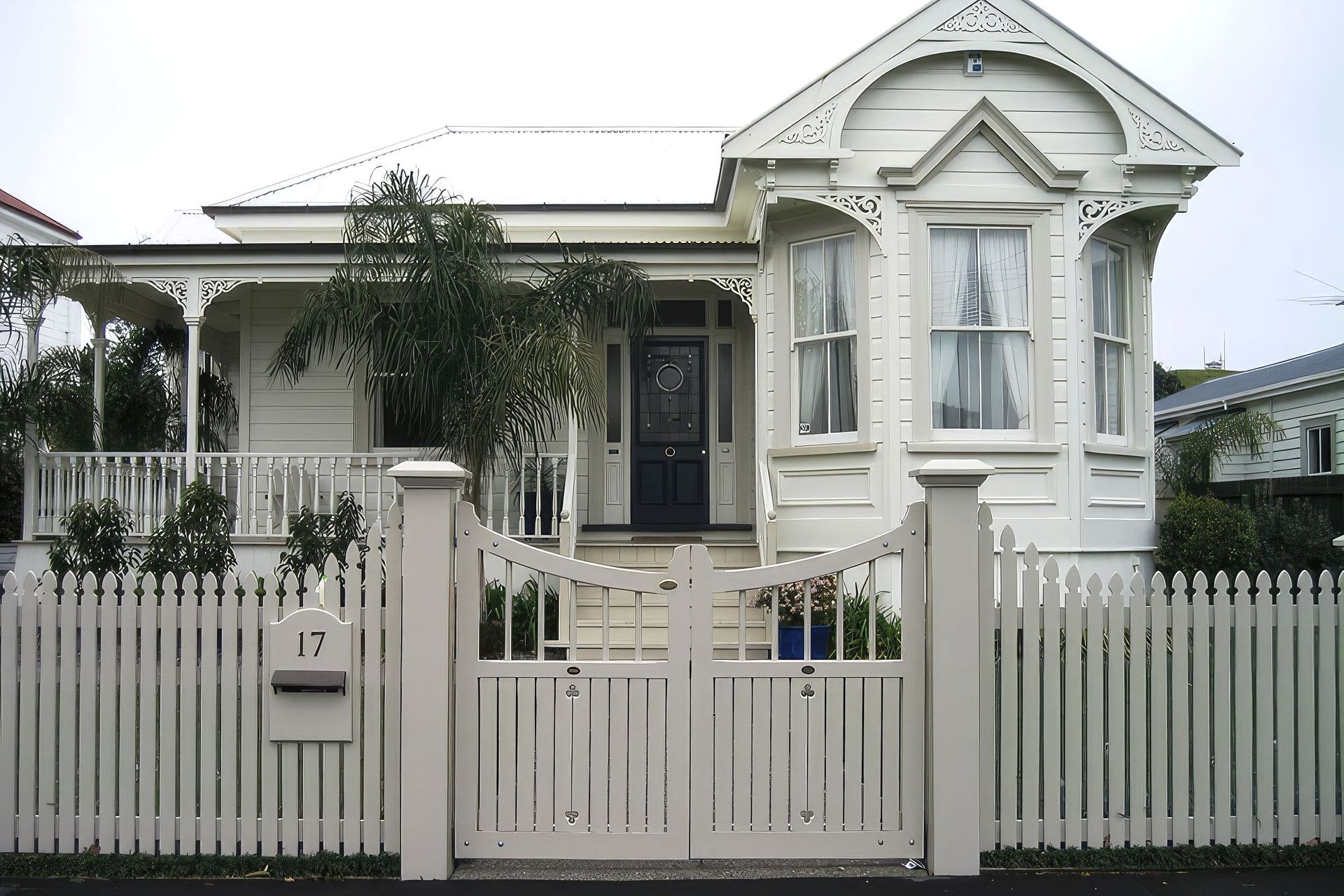 A classic picket fence complemented by Traditional Style Gates by WoodenGates.