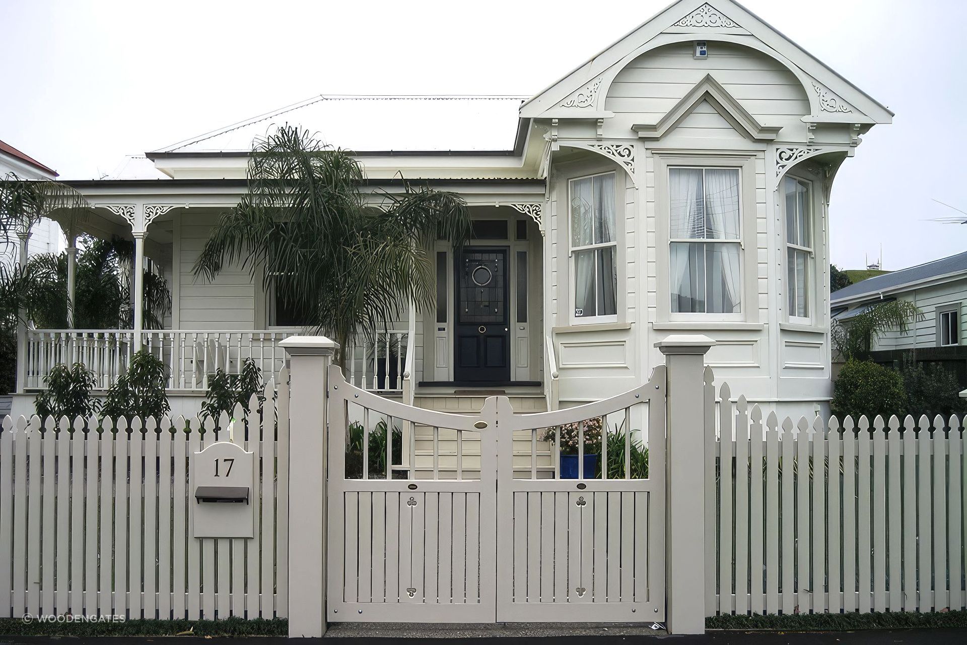 A classic picket fence complemented by Traditional Style Gates by WoodenGates.