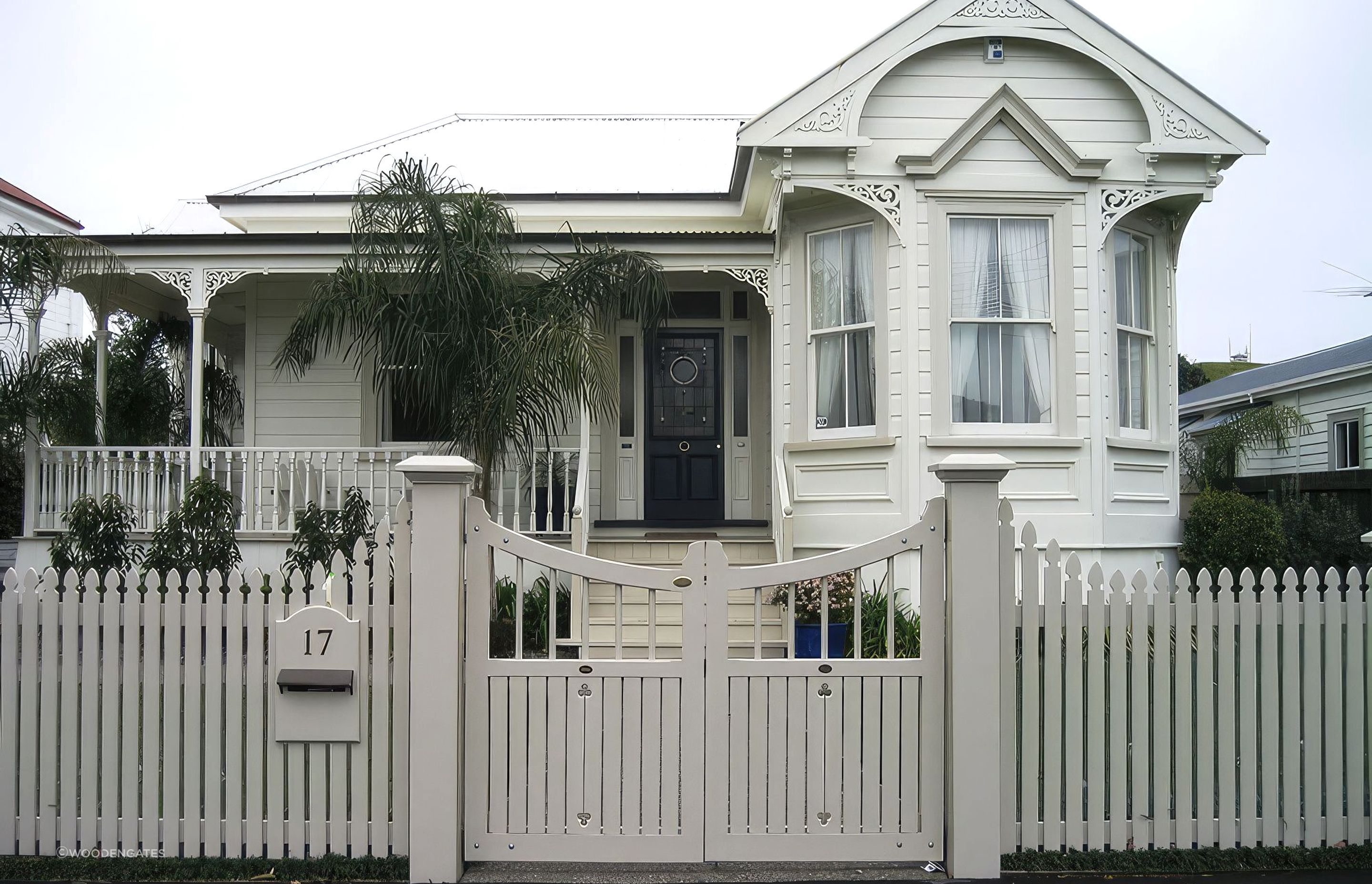 A classic picket fence complemented by Traditional Style Gates by WoodenGates.
