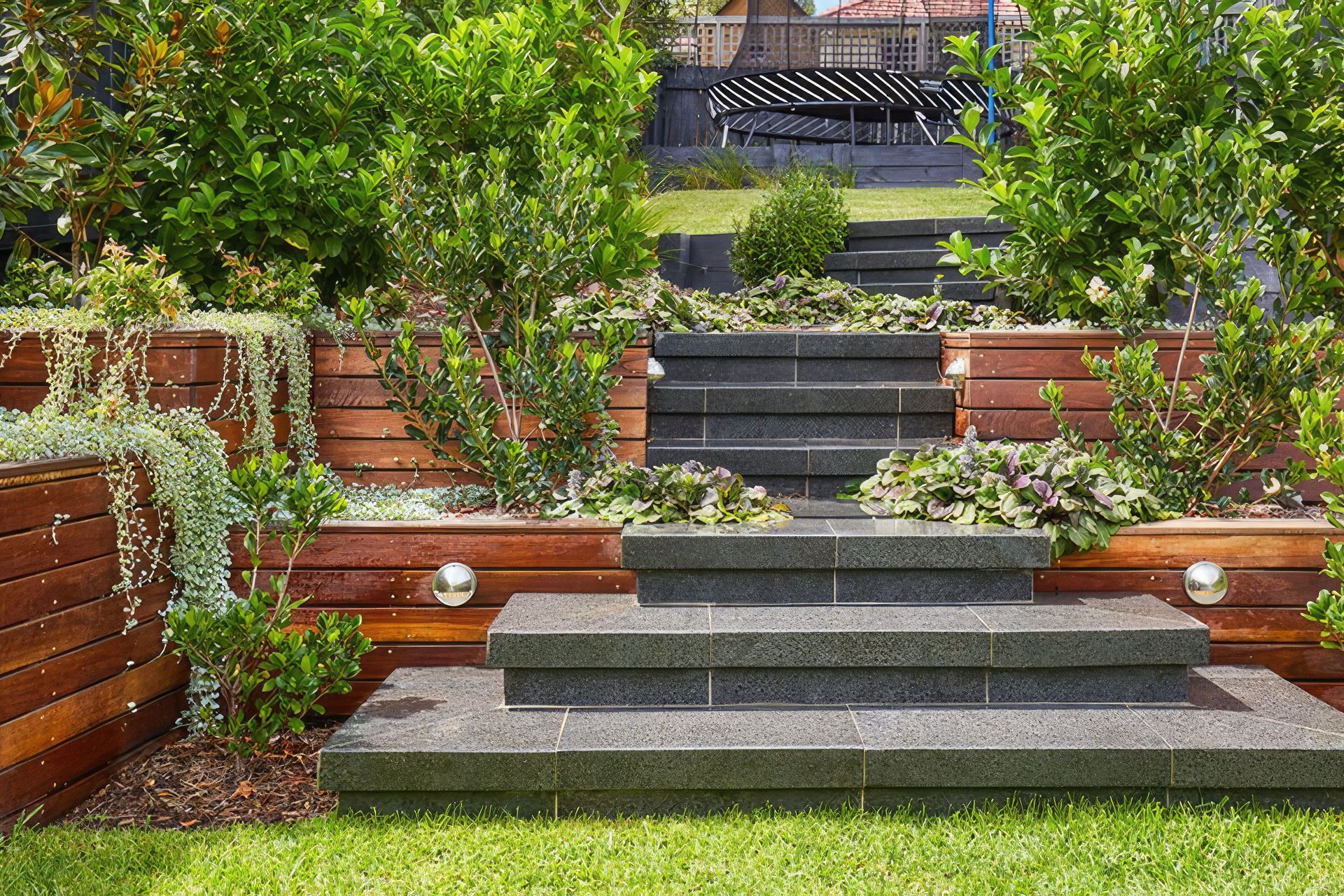 Johnston Crescent Project: Granite stairs connecting the lawn to the kids’ play area.