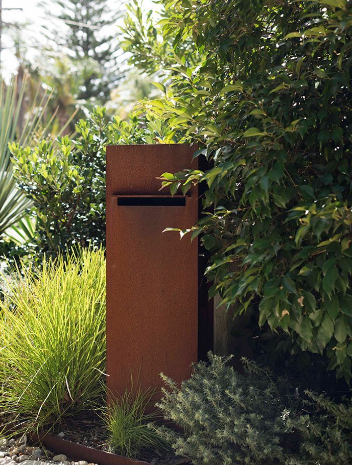 A rustic letter box takes pride of place in this garden