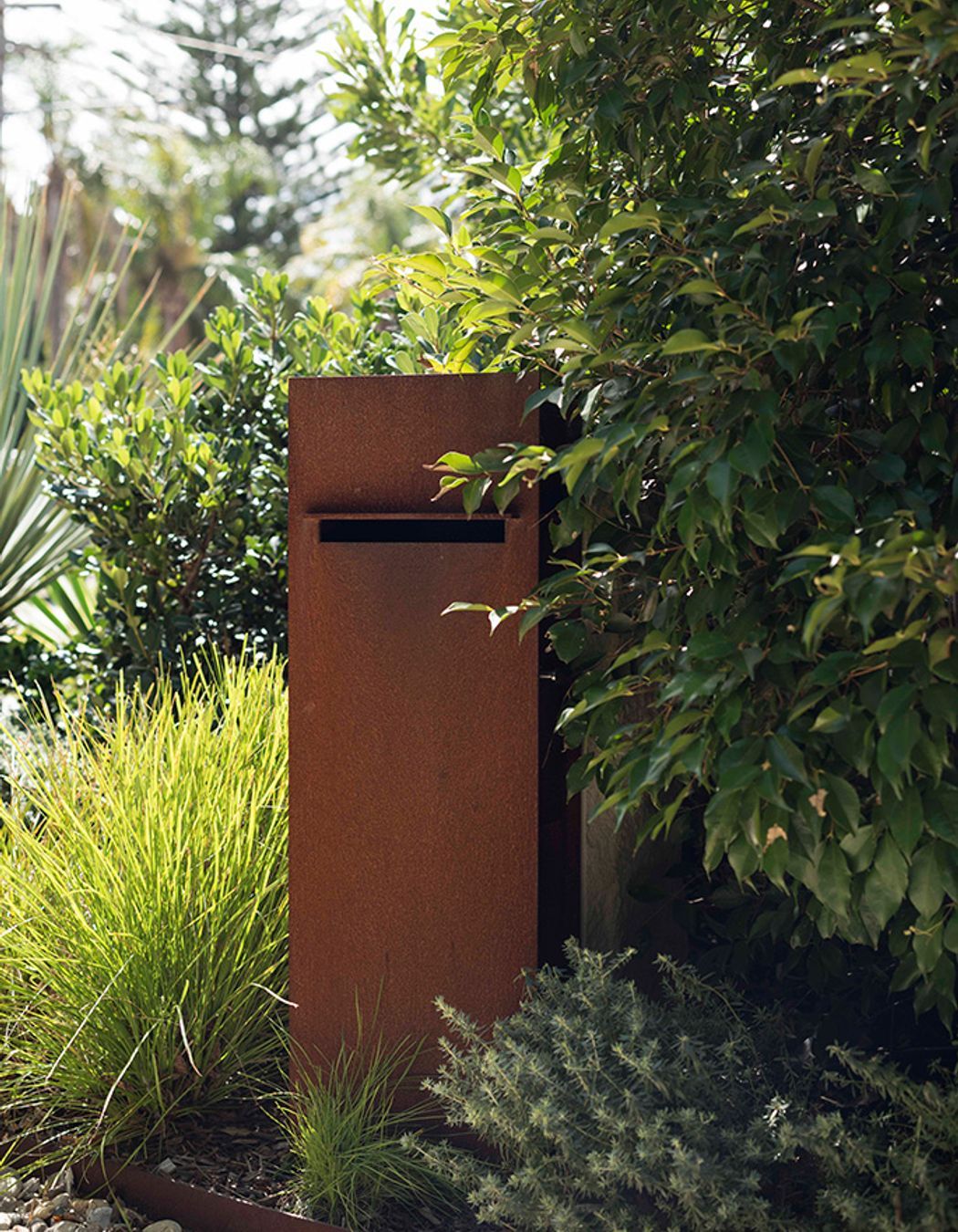 A rustic letter box takes pride of place in this garden