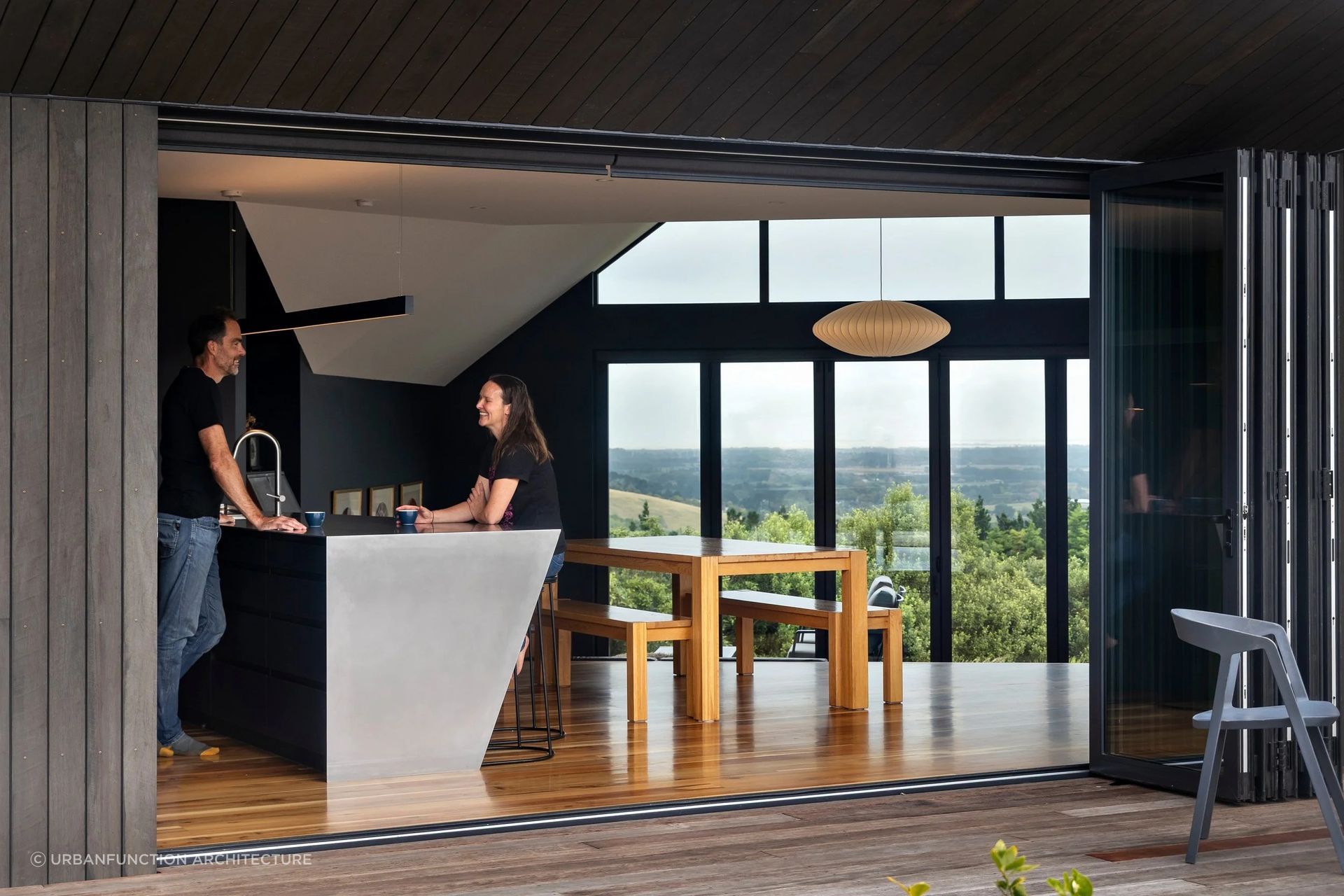 Korimako House by Urbanfunction Architecture is a hillside home defined by three distinct volumes that choreograph movement, view and occupation.