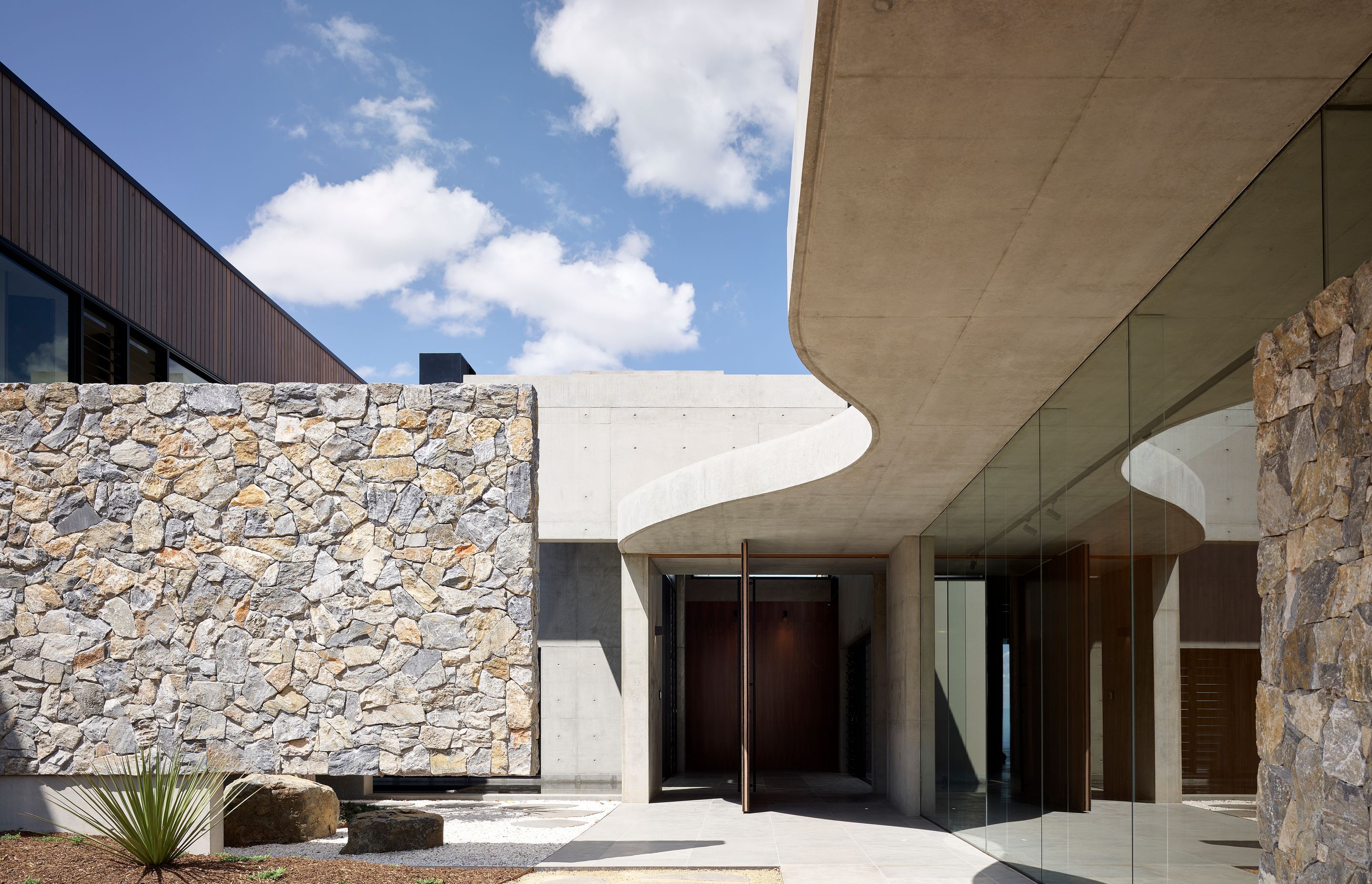 Wamberal Freeform stone walling is ideal for residential and commercial applicatons. Here, it's been teamed with Andorra limestone pavers, which exhibit light grey hues. Photography by Scott Burrows.